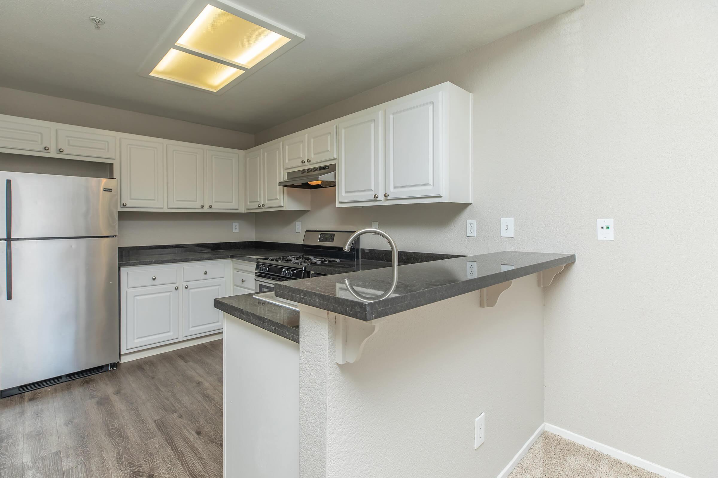 a kitchen with a sink and a refrigerator