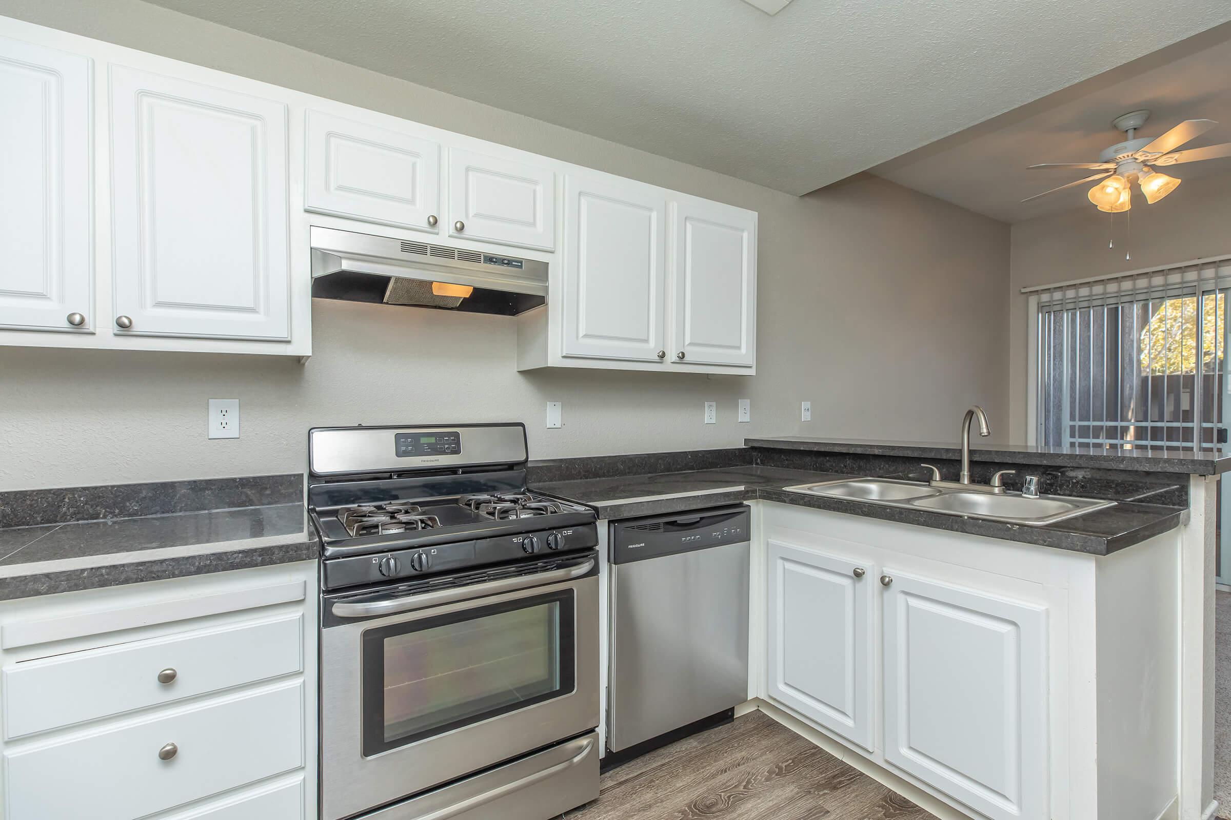 a stove top oven sitting inside of a kitchen