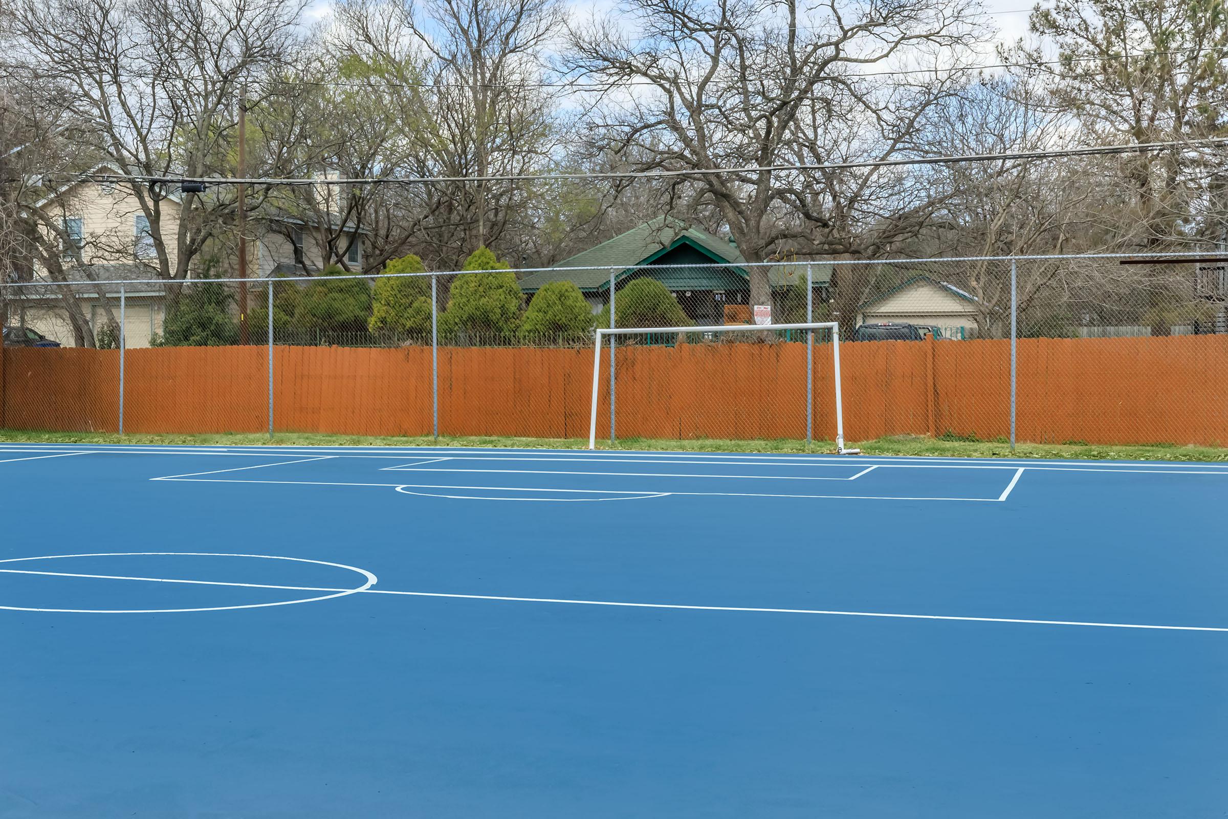 a basketball on a court with a racket