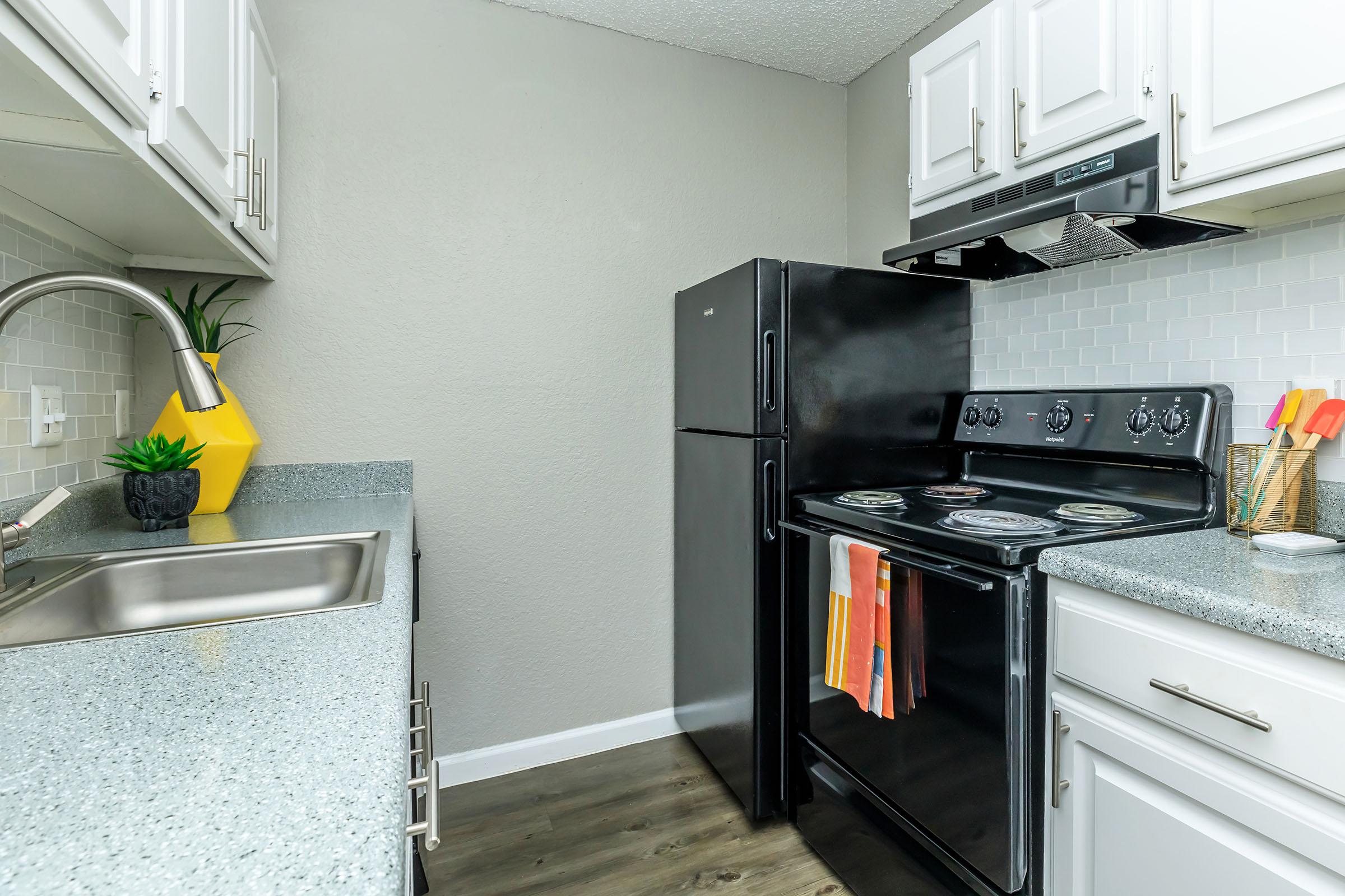 a kitchen with a stove top oven sitting inside of a refrigerator