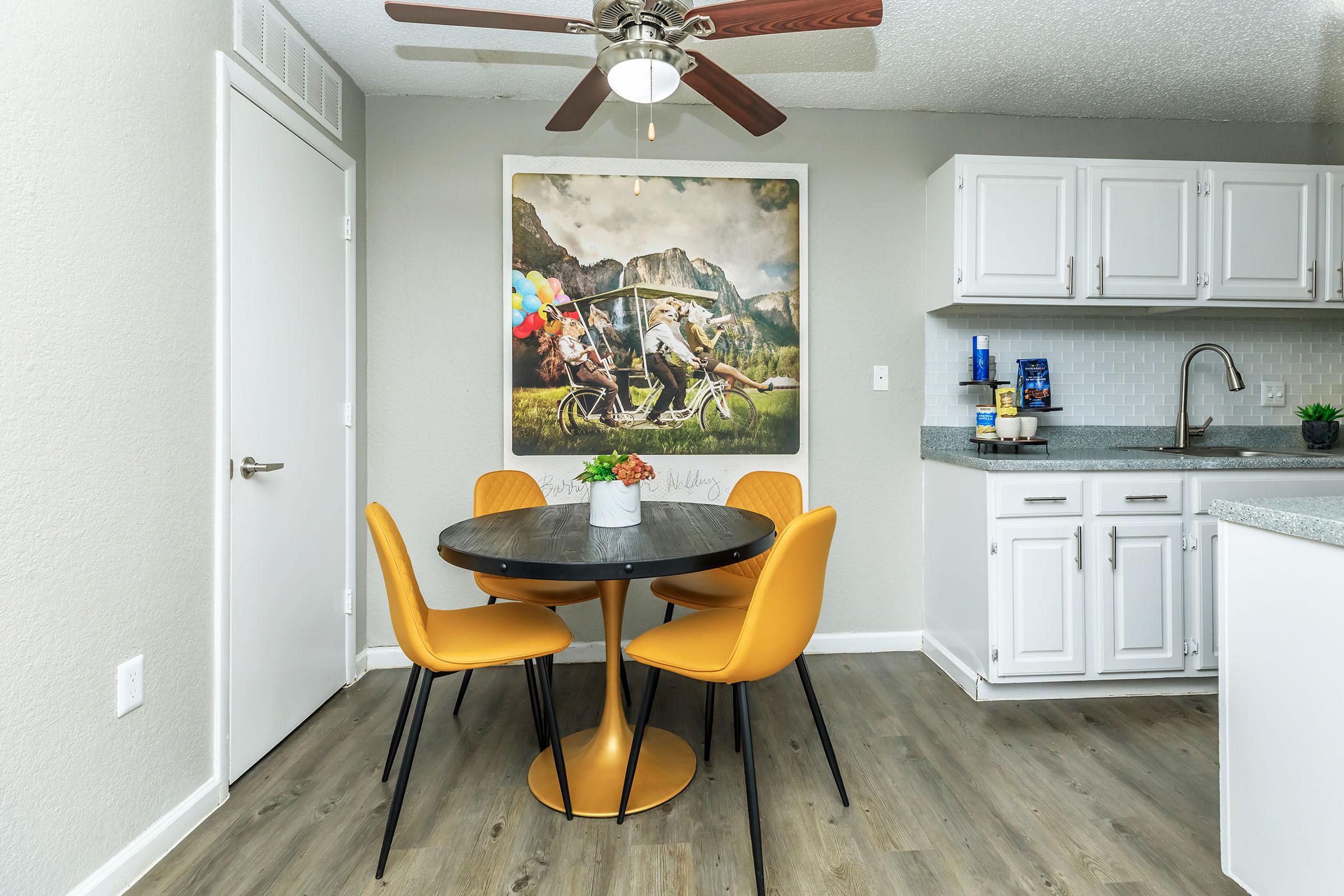 a kitchen with a table and chairs