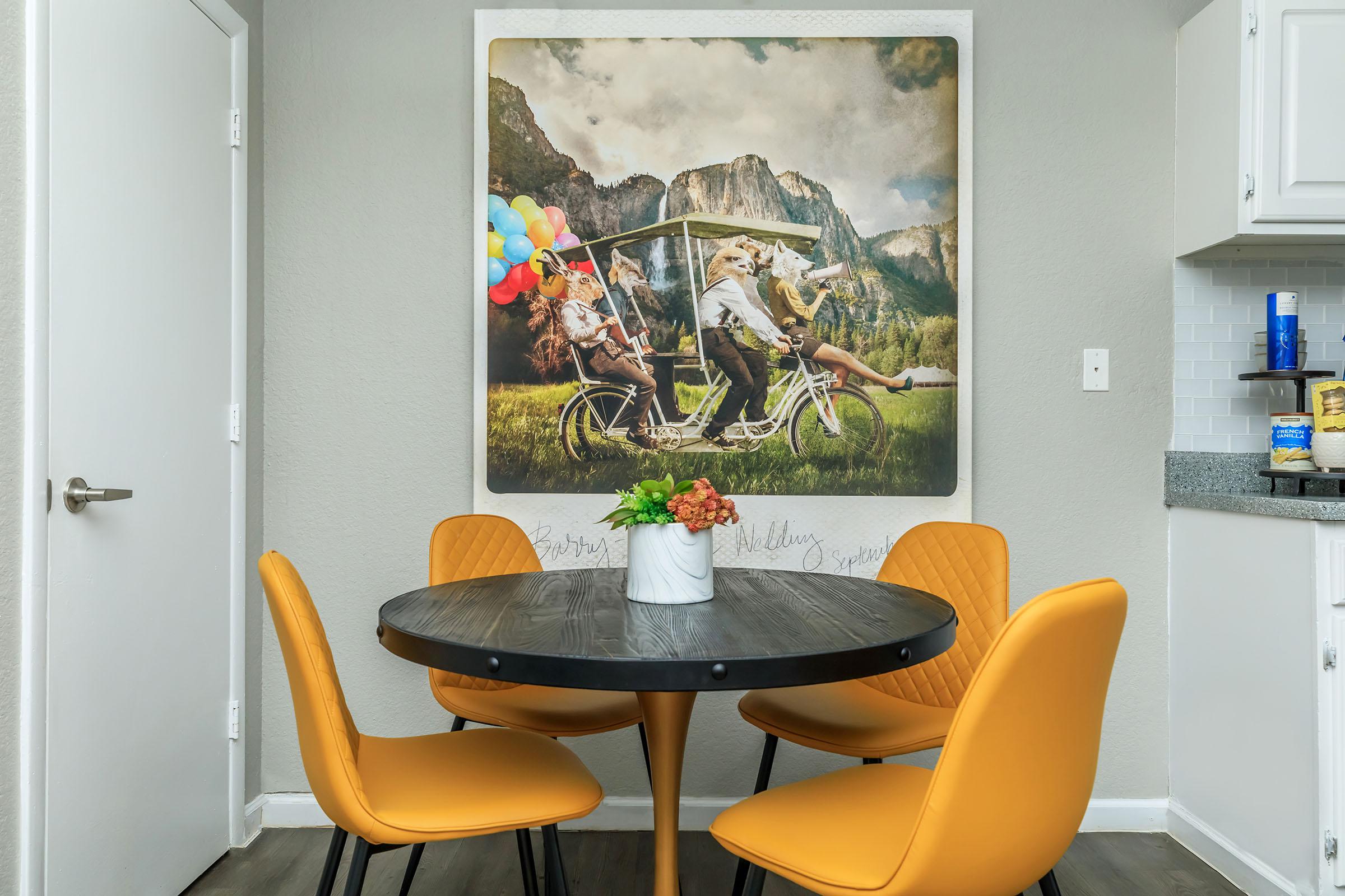 a desk with a computer and a chair in a room