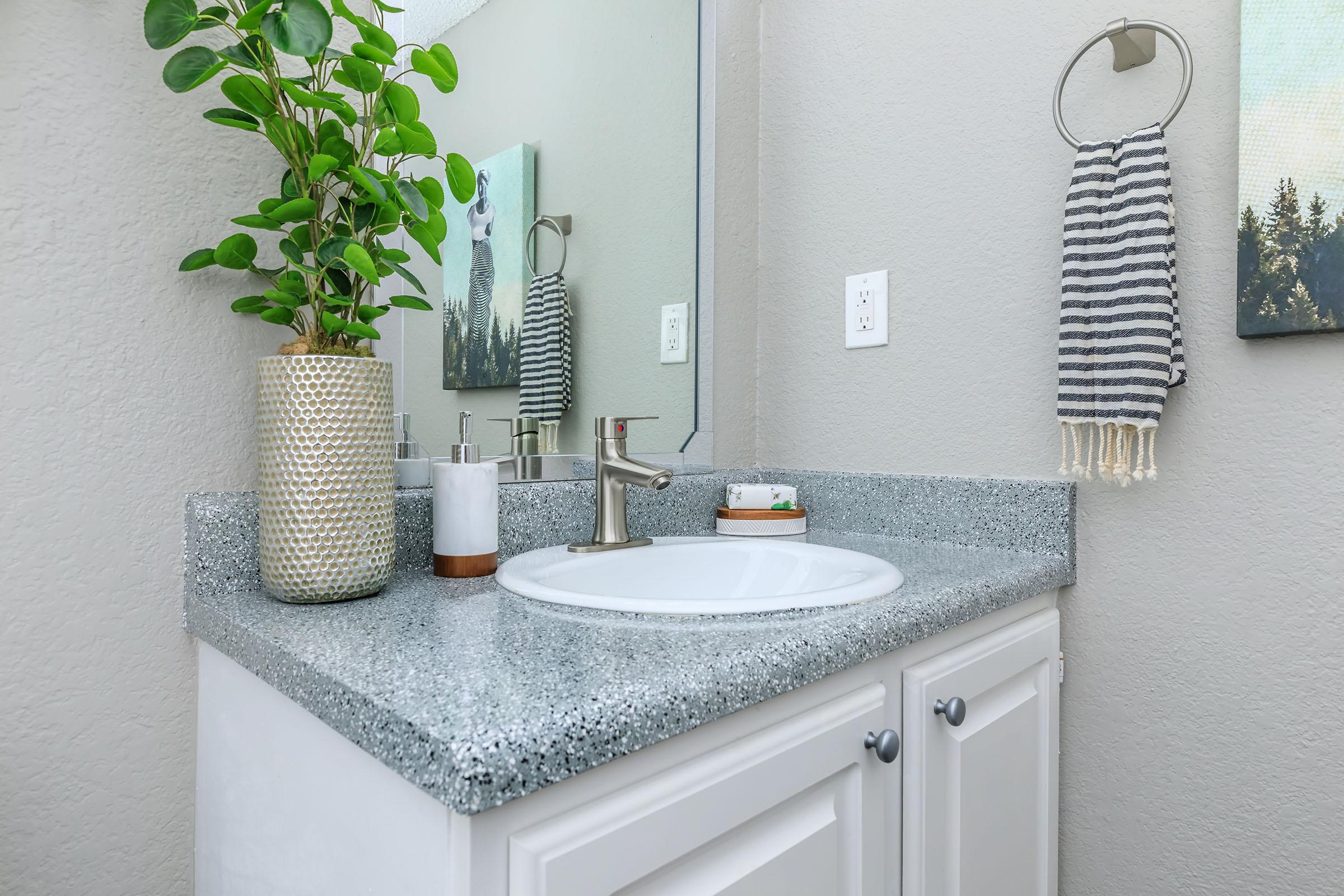 a kitchen with a sink and a mirror