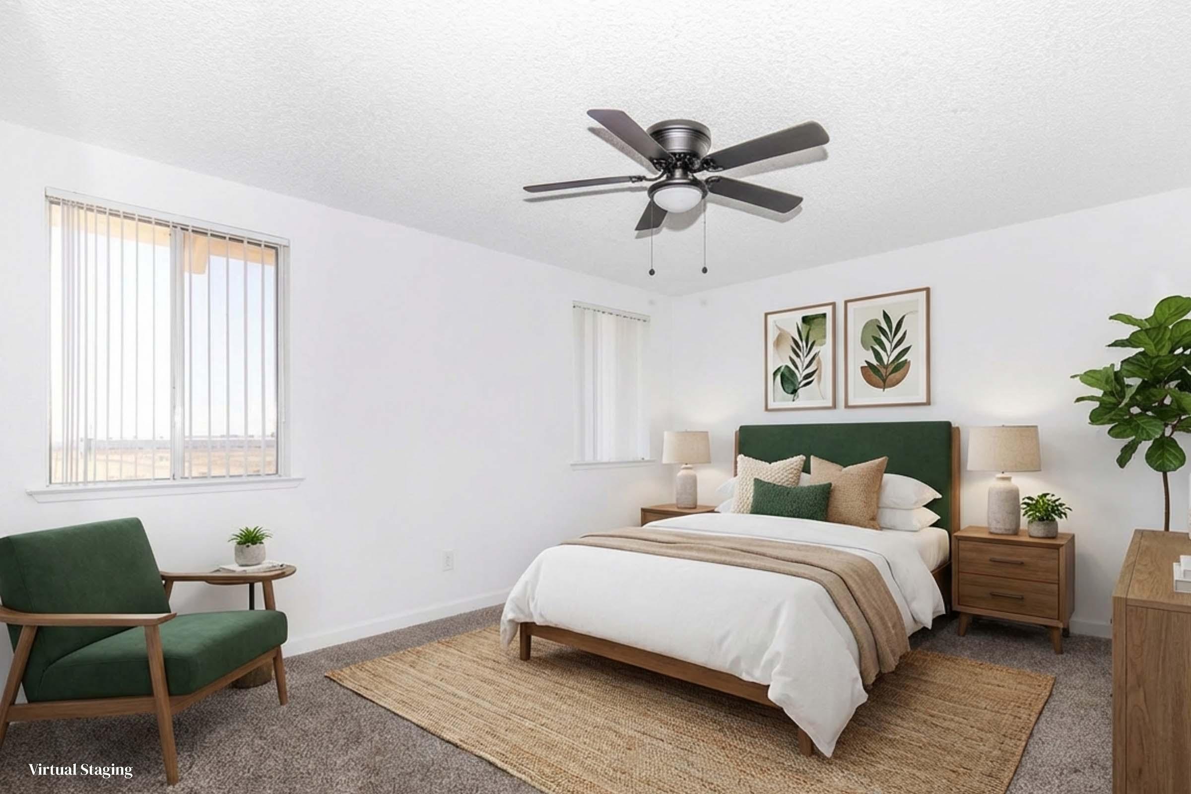 A modern bedroom featuring a queen-sized bed with a green headboard, layered bedding, and decorative pillows. There are two wooden nightstands with lamps on either side of the bed. A cozy rug lies on the carpeted floor, and a green accent chair is positioned nearby. Large windows provide natural light, and potted plants add a touch of greenery.