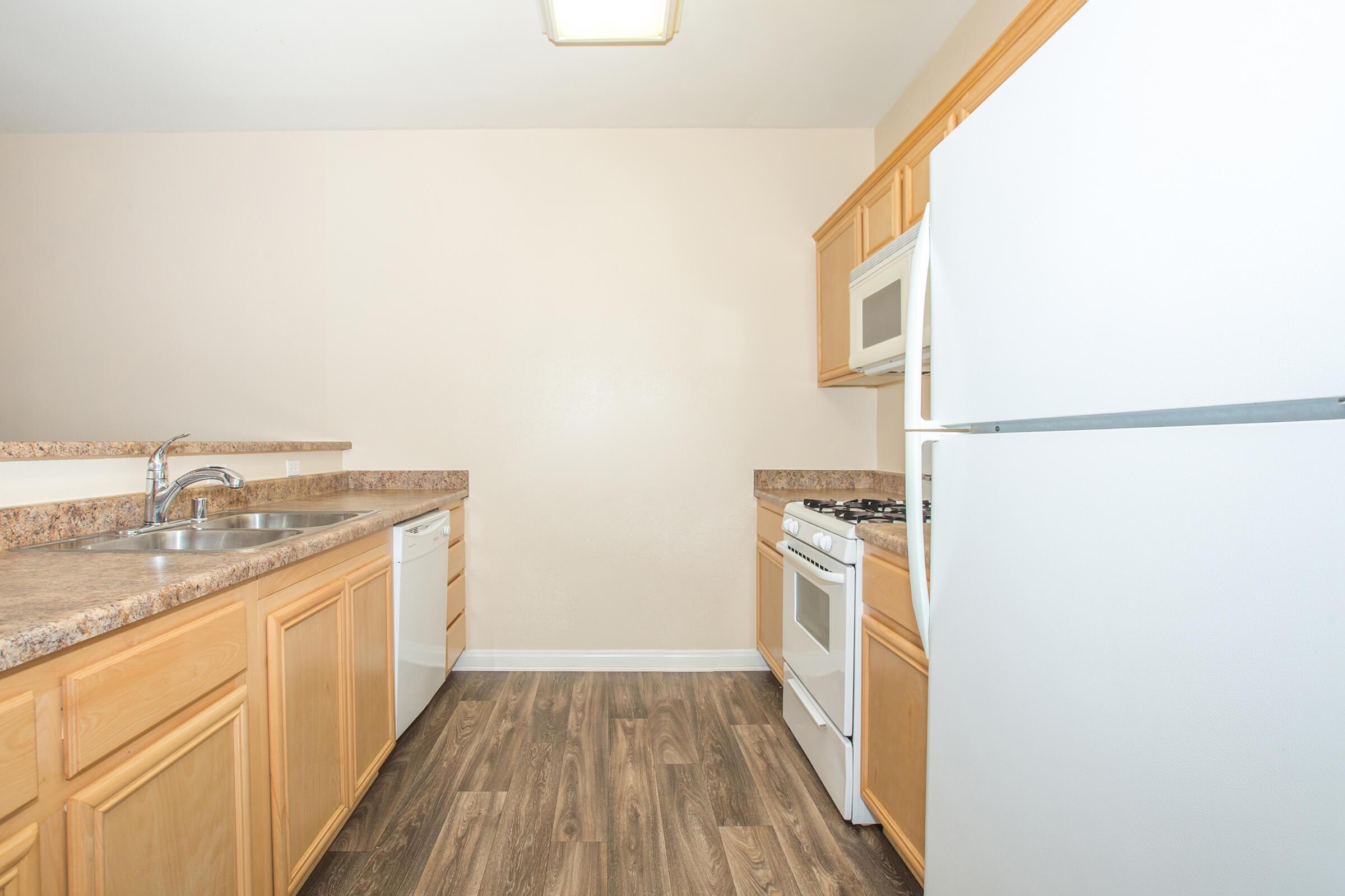 a kitchen with a sink and a refrigerator