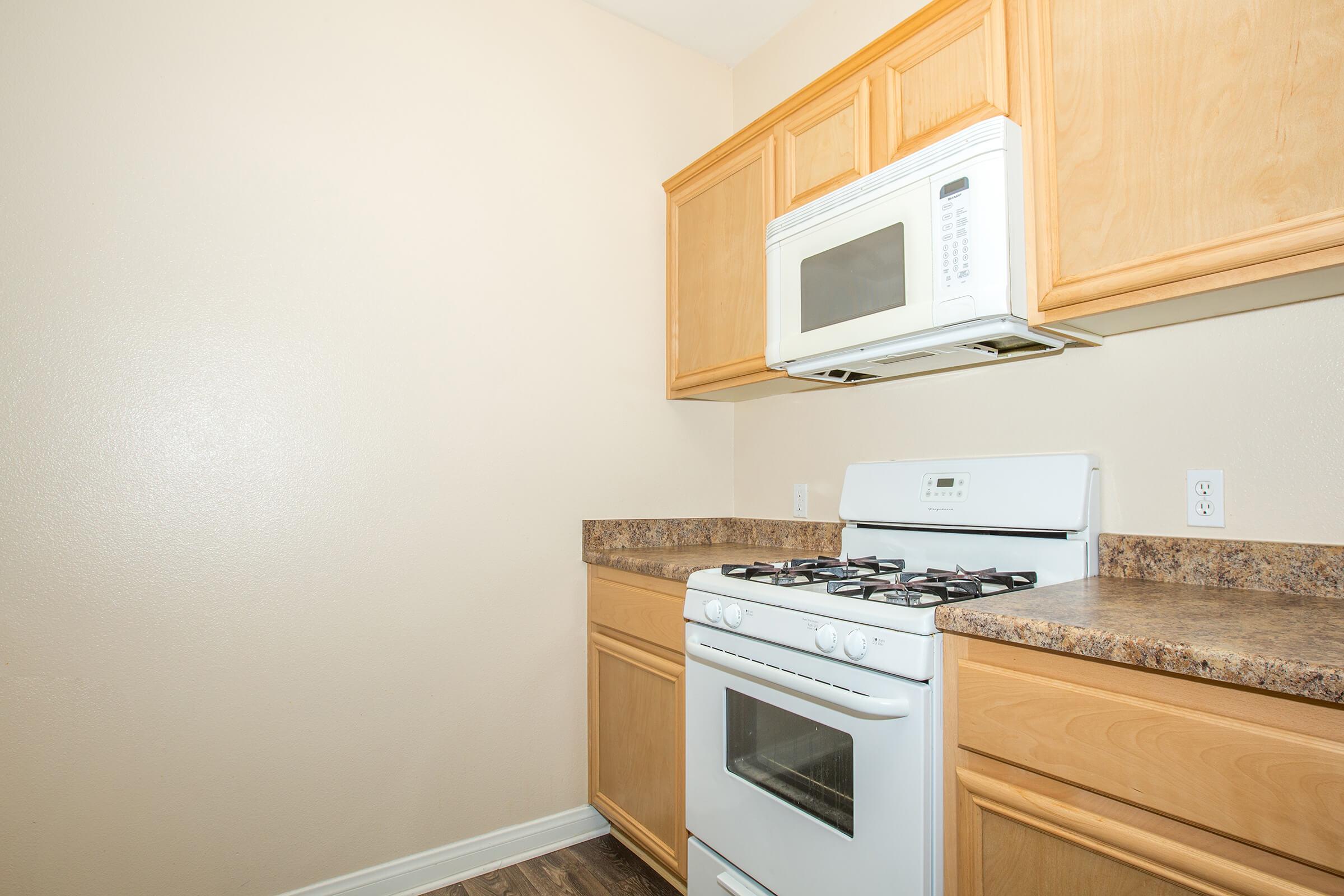 a stove top oven sitting inside of a kitchen