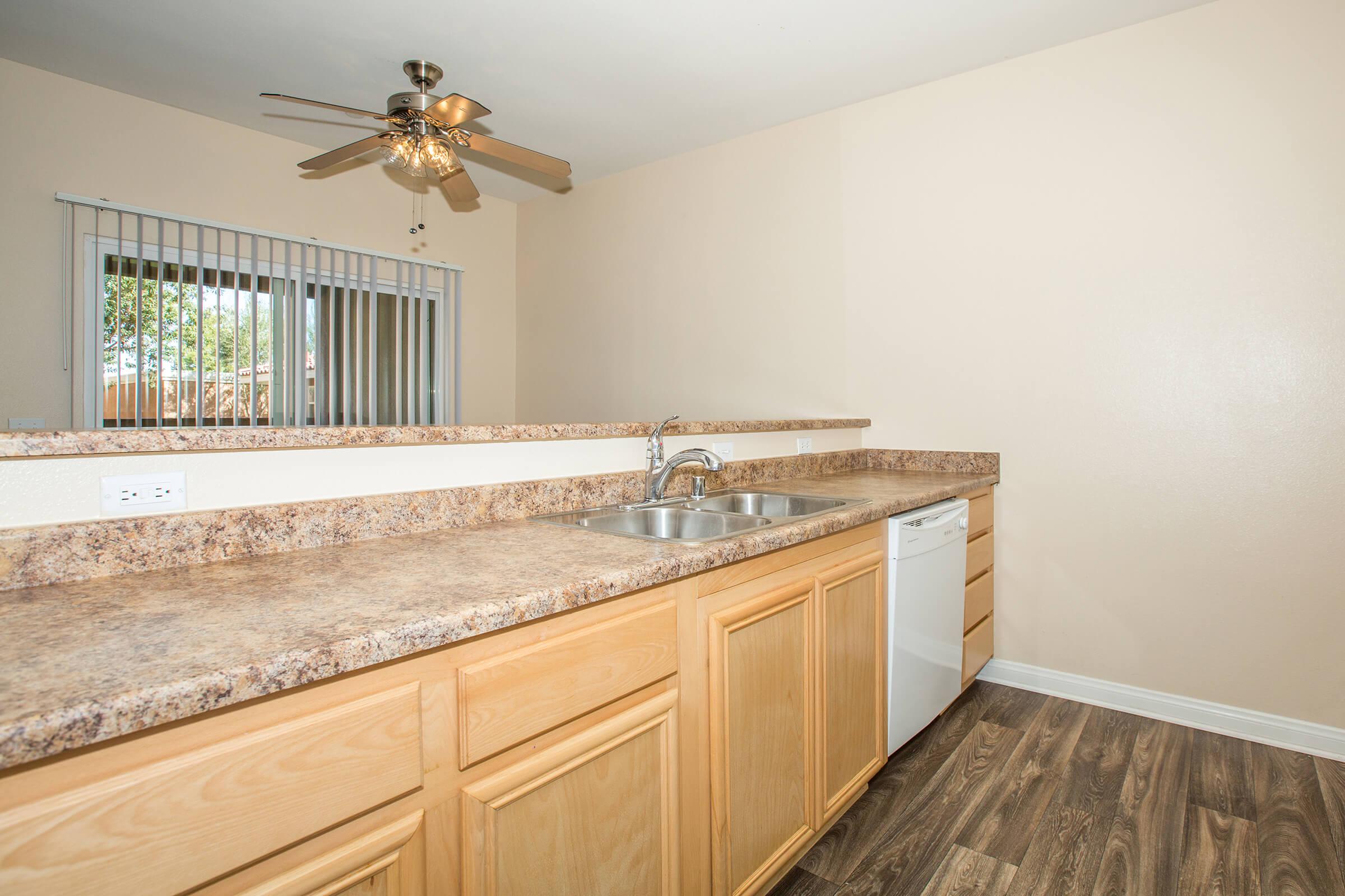 a kitchen with a sink and a mirror