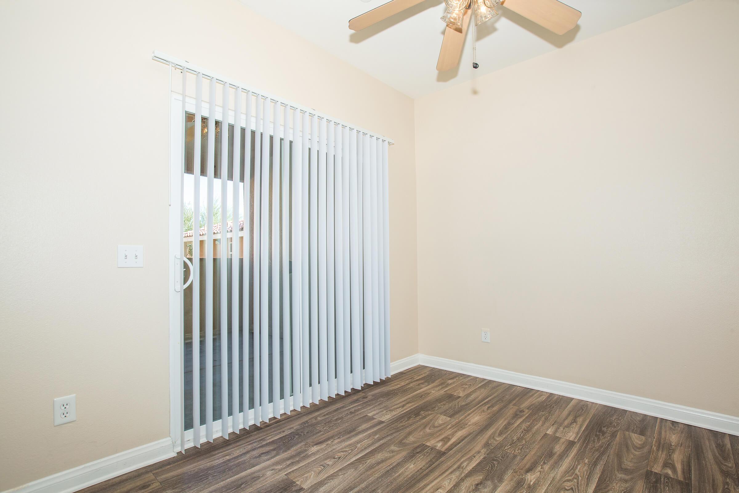 a bedroom with a building in the background