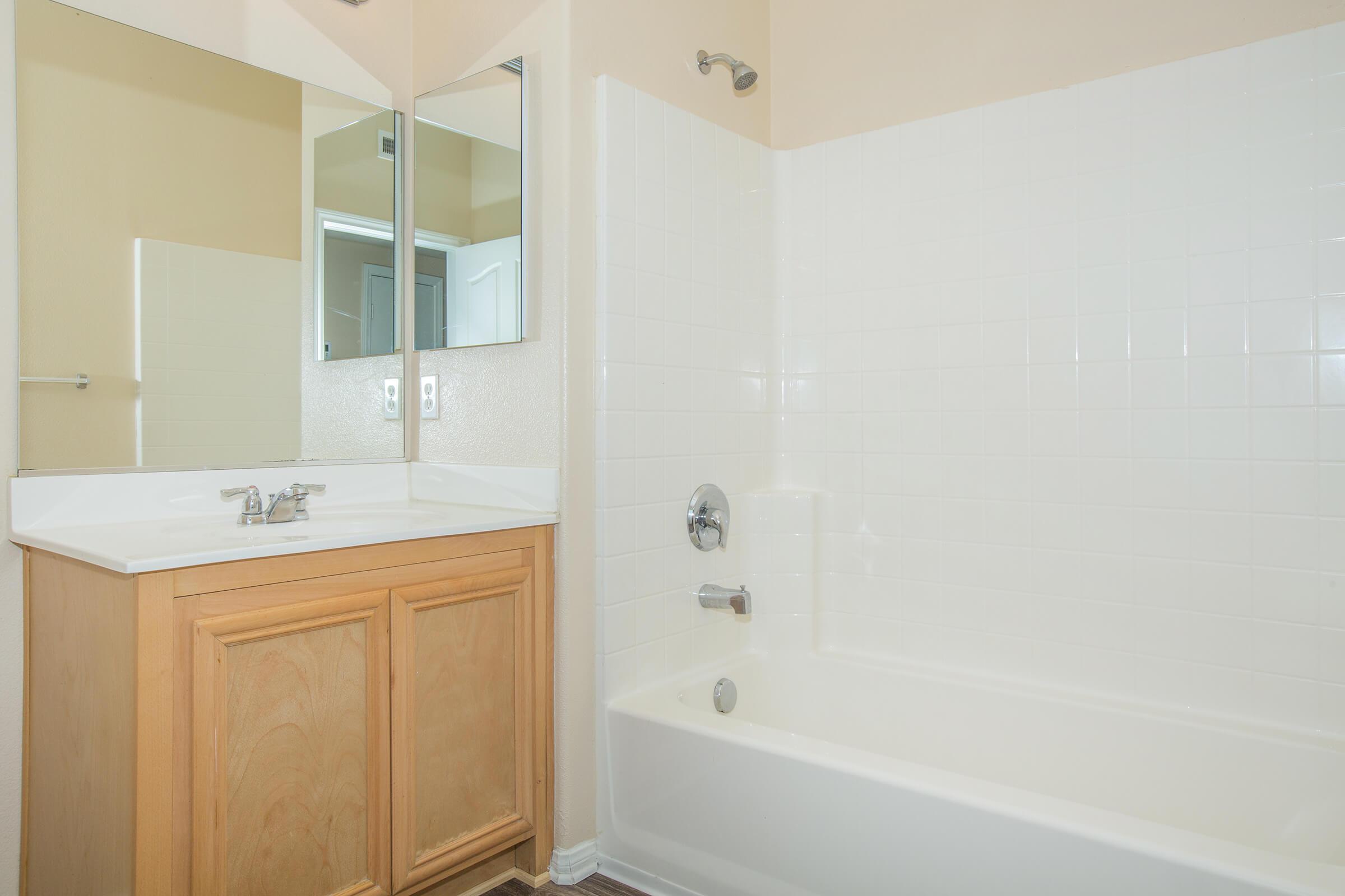 a large white tub next to a shower