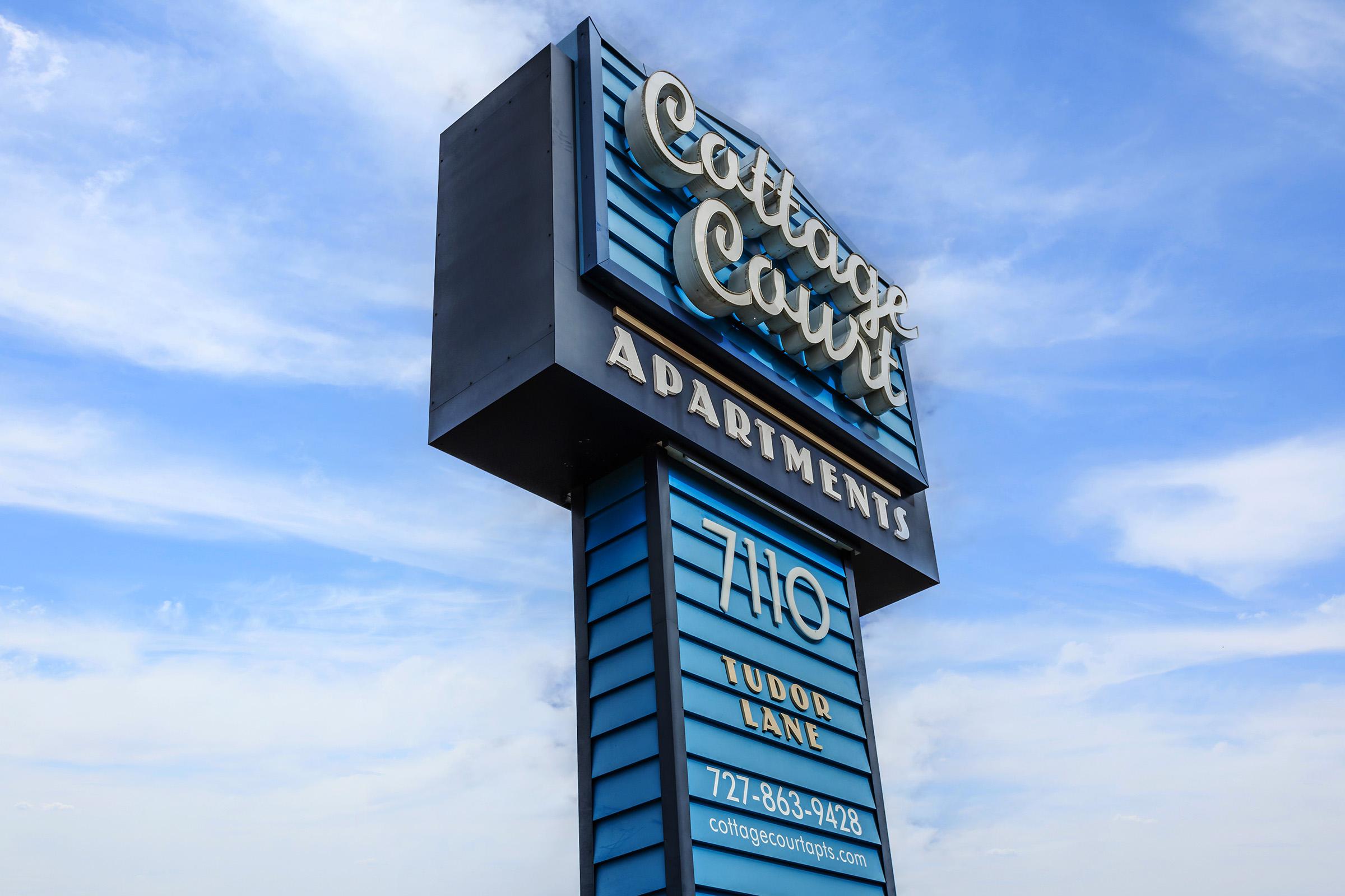 a tall clock tower sitting next to a sign