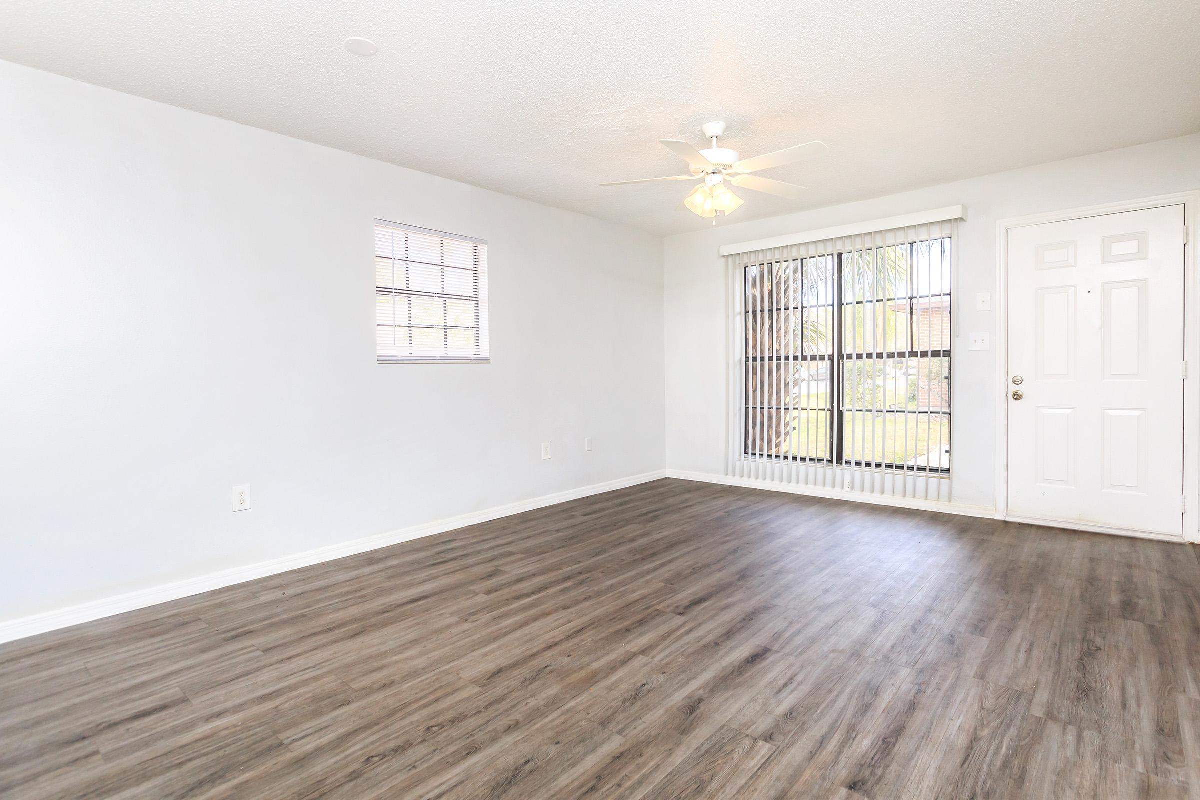 a large empty room with a wooden floor