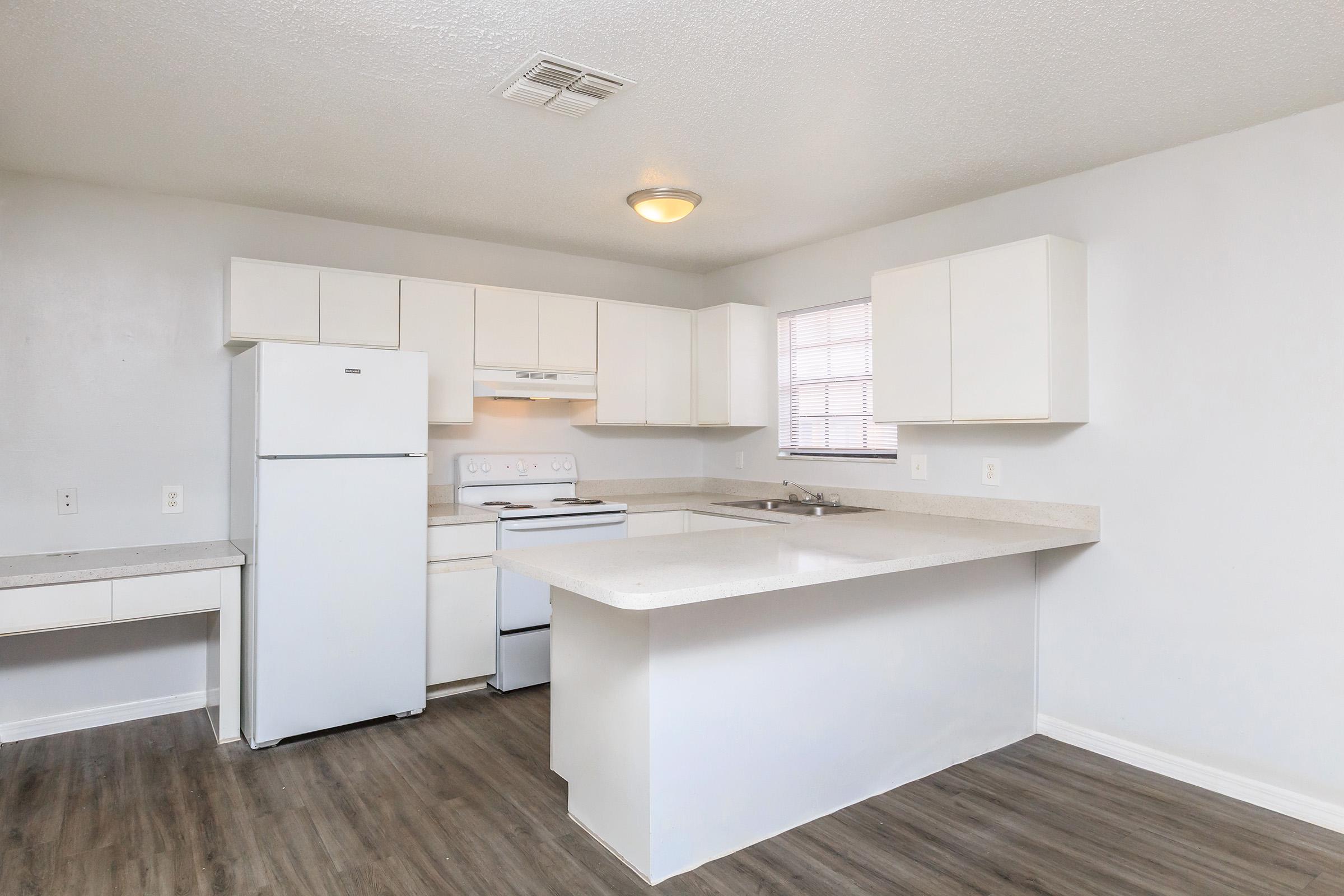 a kitchen with a stove and a refrigerator