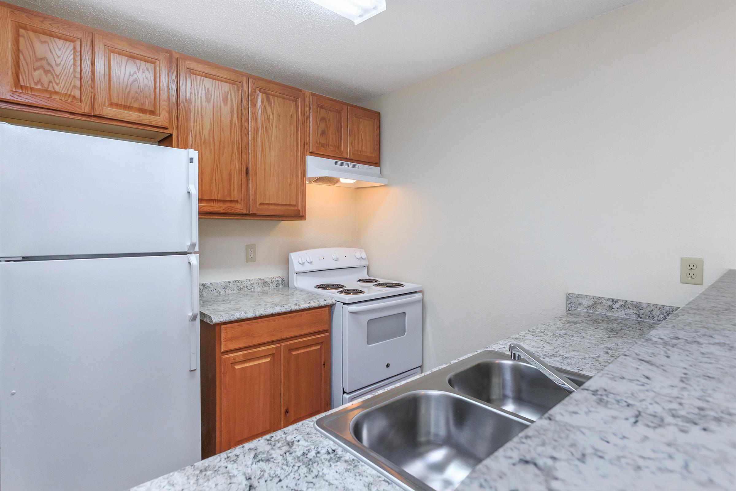 a kitchen with a stove and a refrigerator