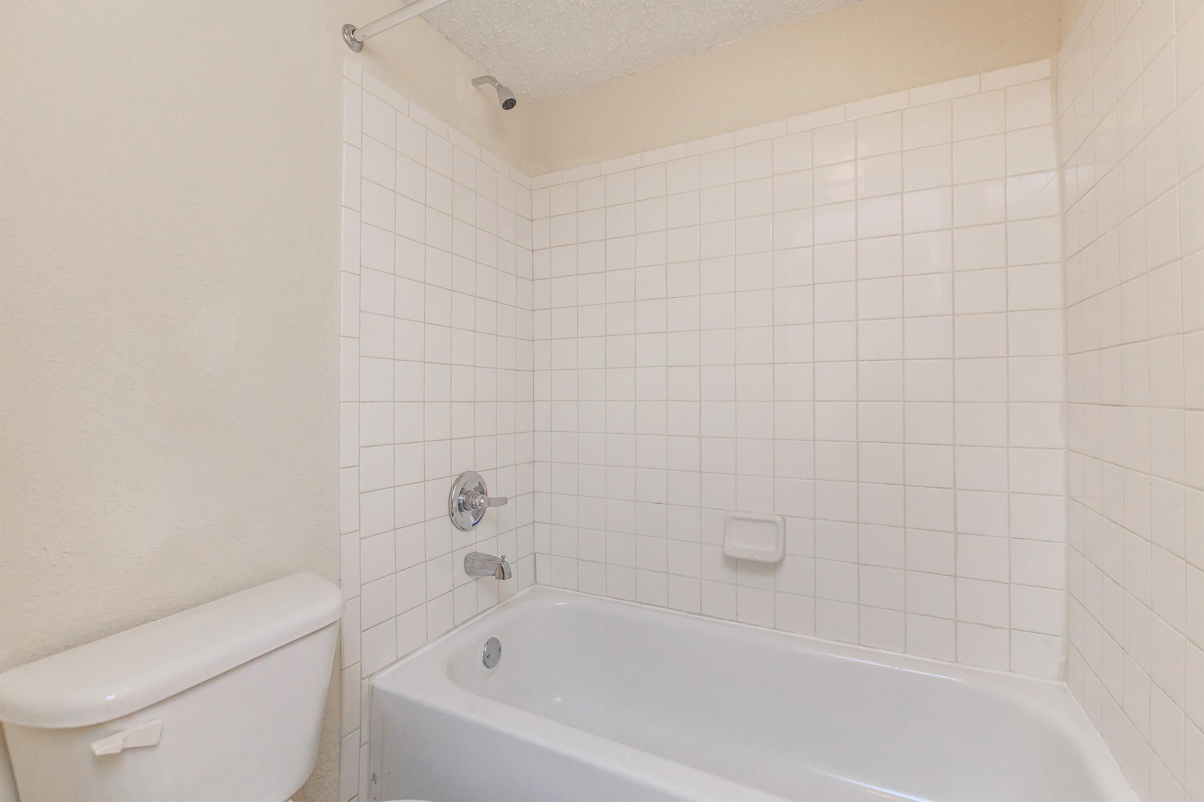 a white tub sitting next to a sink