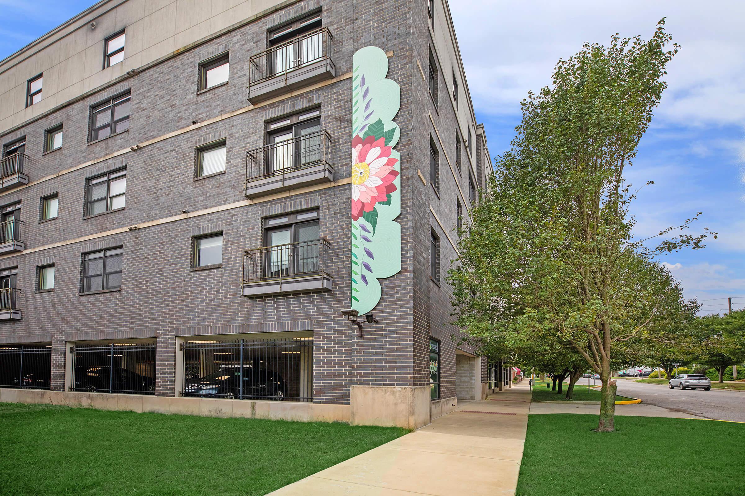 a large lawn in front of a brick building