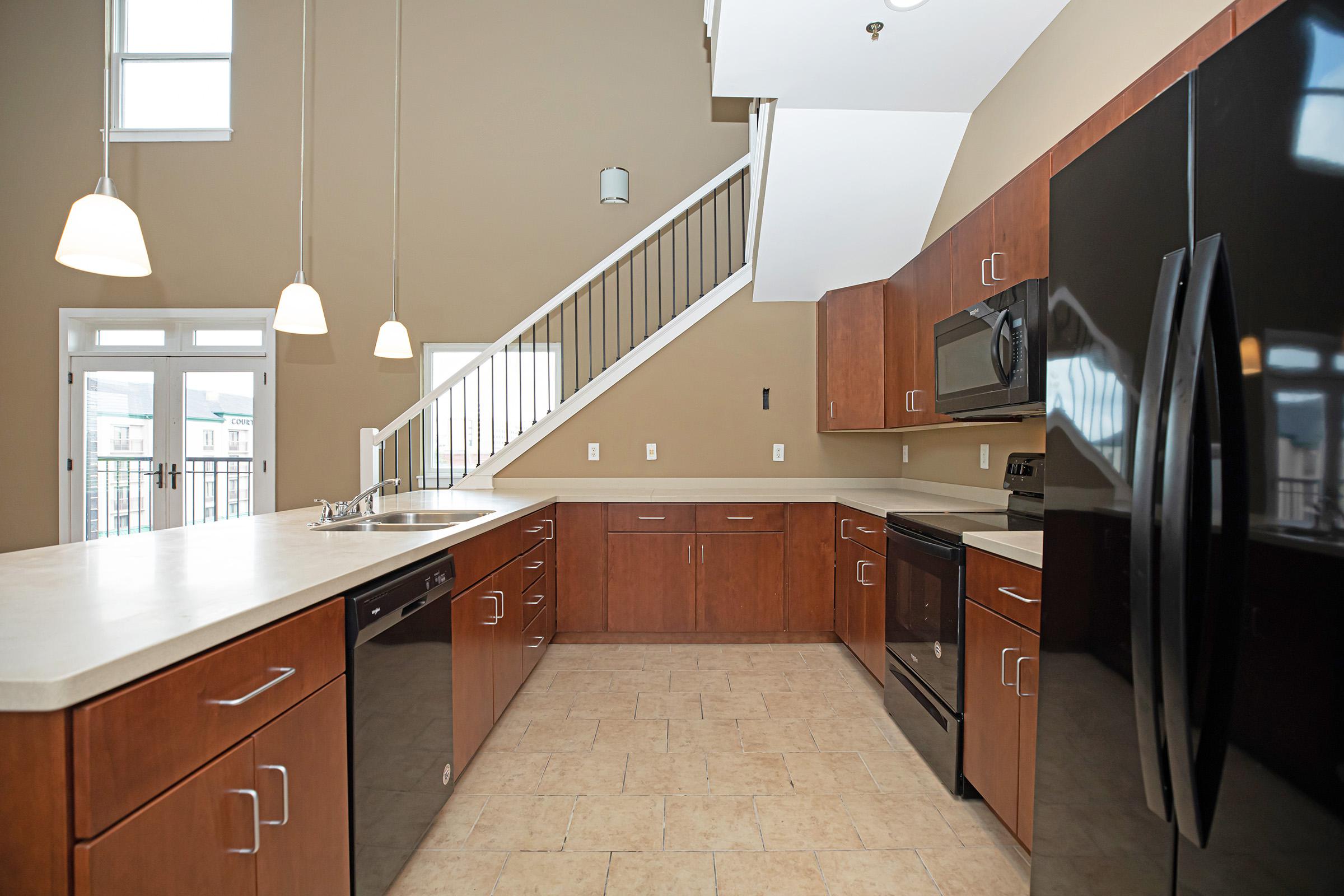 a kitchen with stainless steel appliances and wooden cabinets