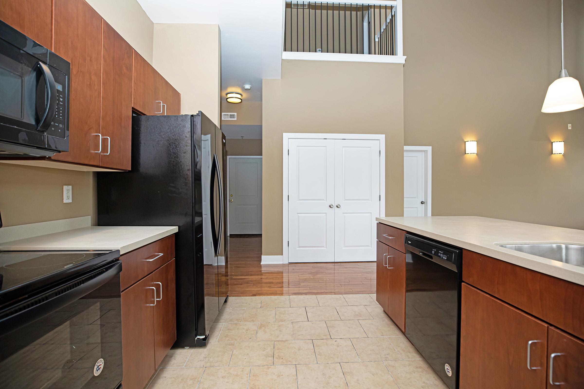 a modern kitchen with stainless steel appliances and wooden cabinets