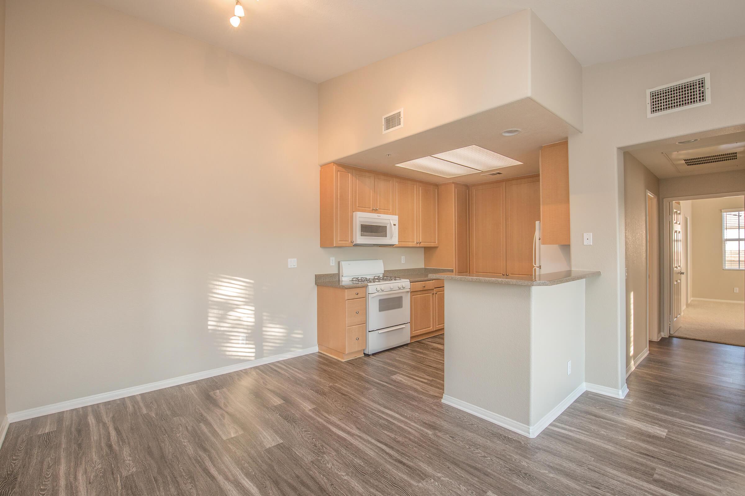 Dining room and kitchen with wooden floors