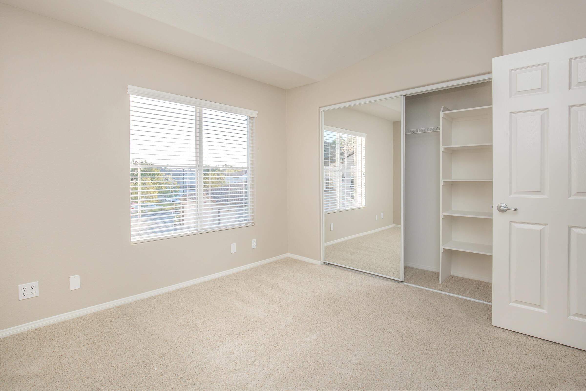 Bedroom with sliding mirror glass closet doors