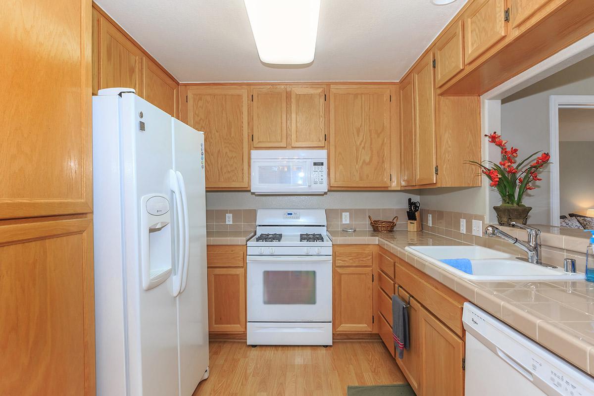 a kitchen with a white stove top oven sitting inside of a refrigerator