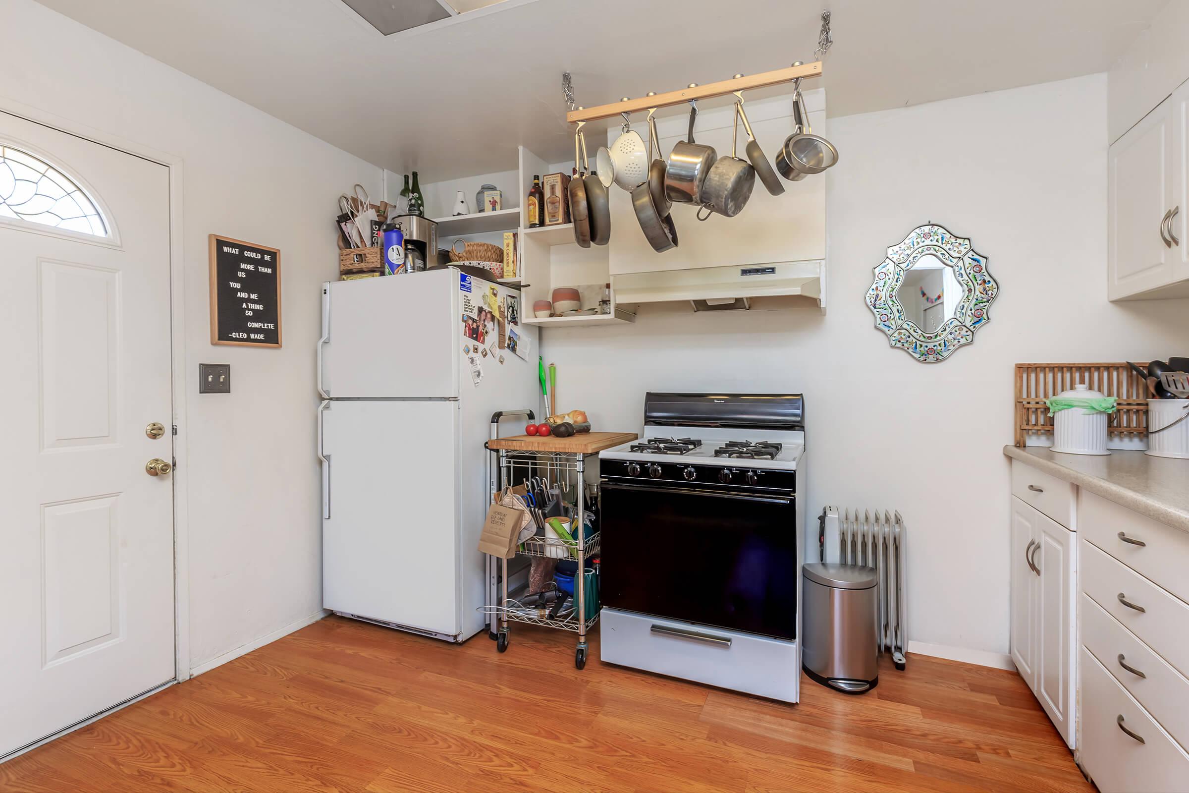 a kitchen with a stove top oven sitting inside of a room