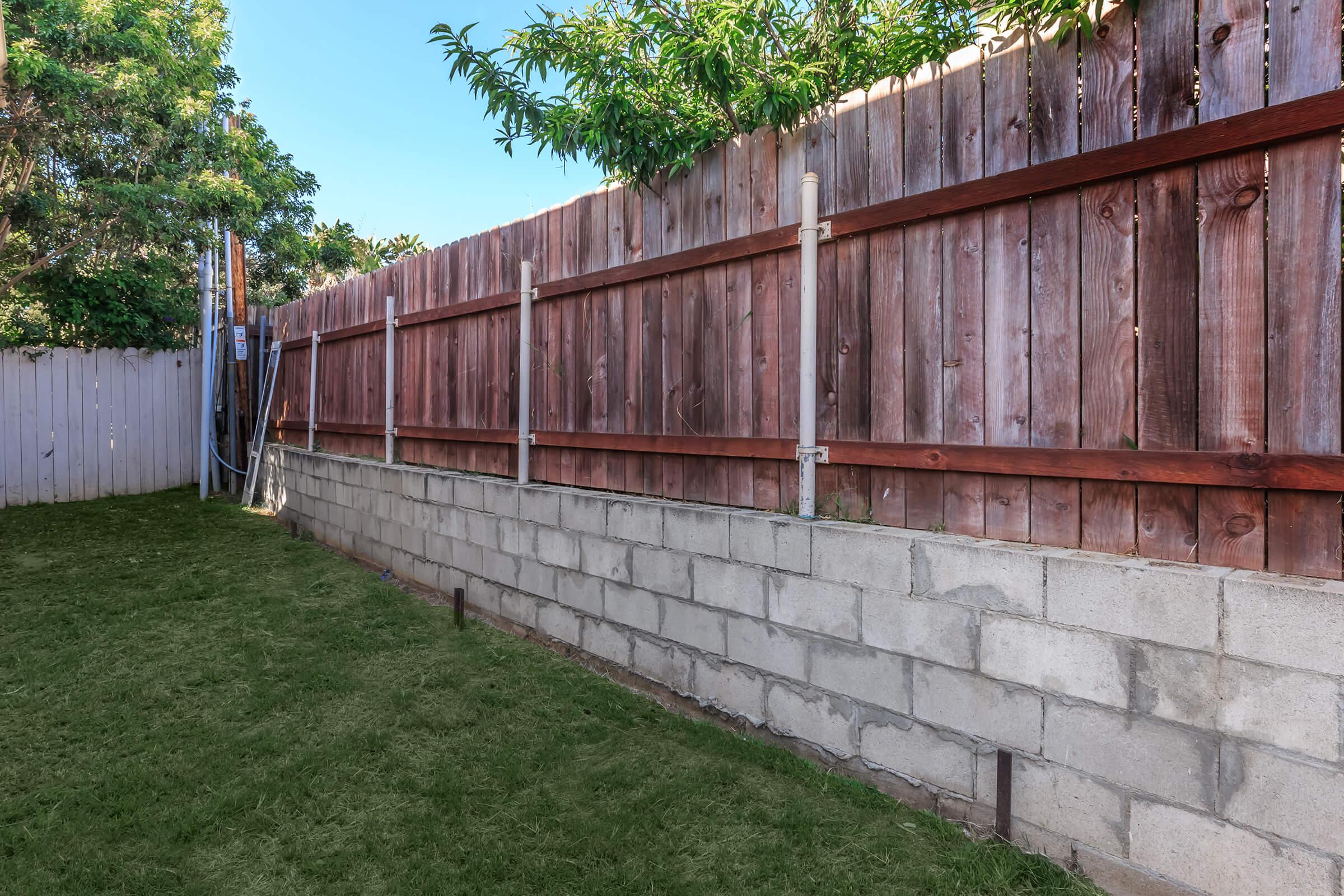 a yard with grass and a fence