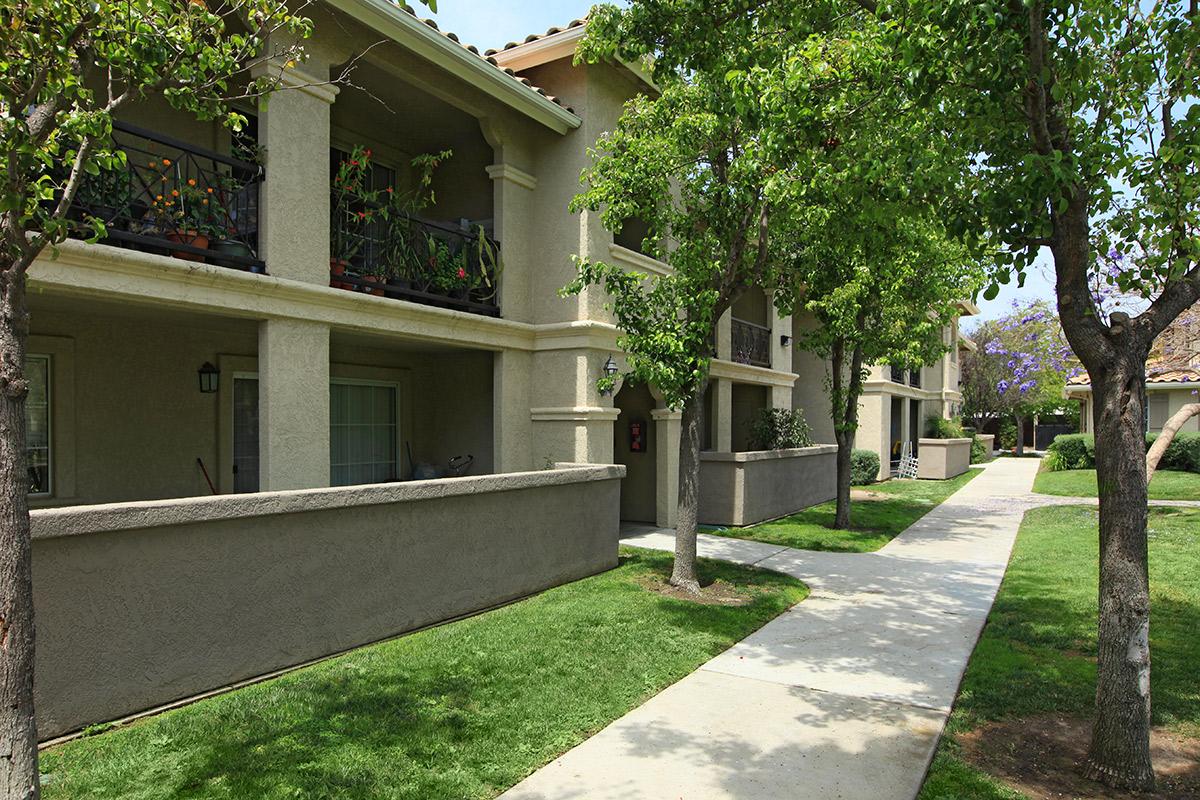 Vineyard Gardens Apartment Homes community building with green trees