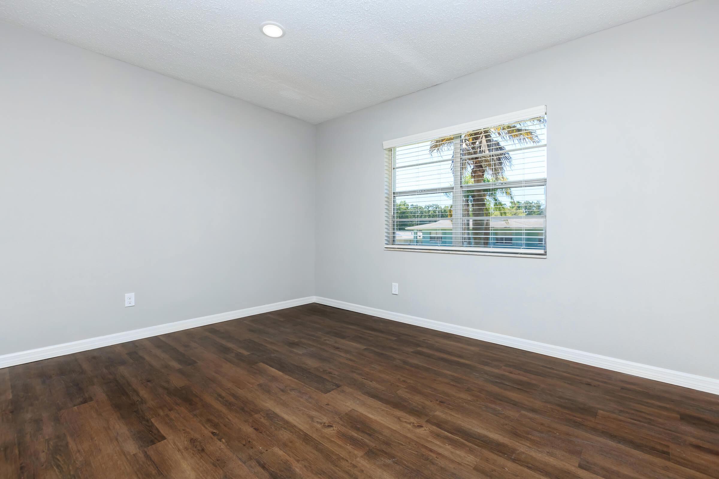 a large empty room with a wooden floor