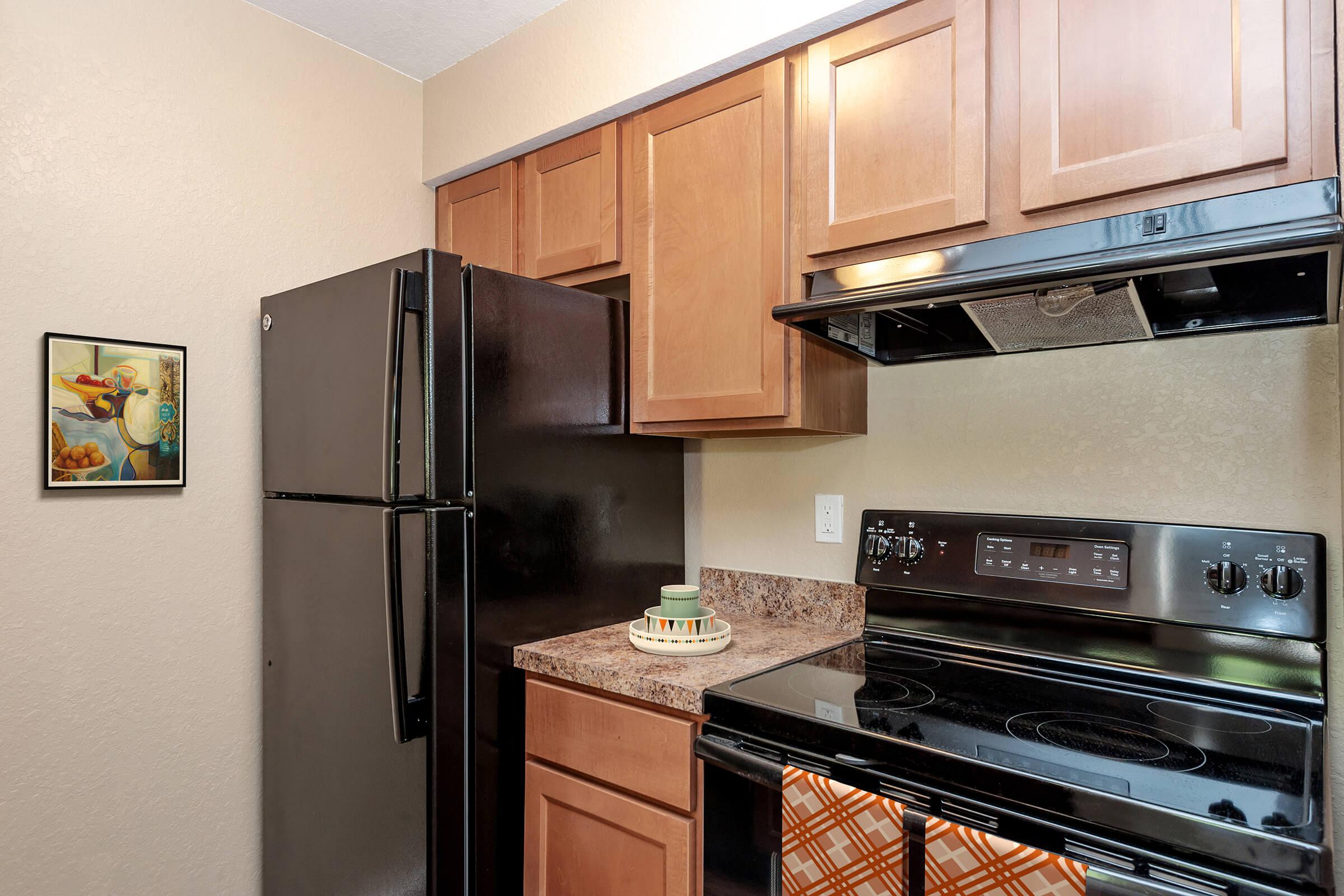a stove top oven sitting inside of a kitchen