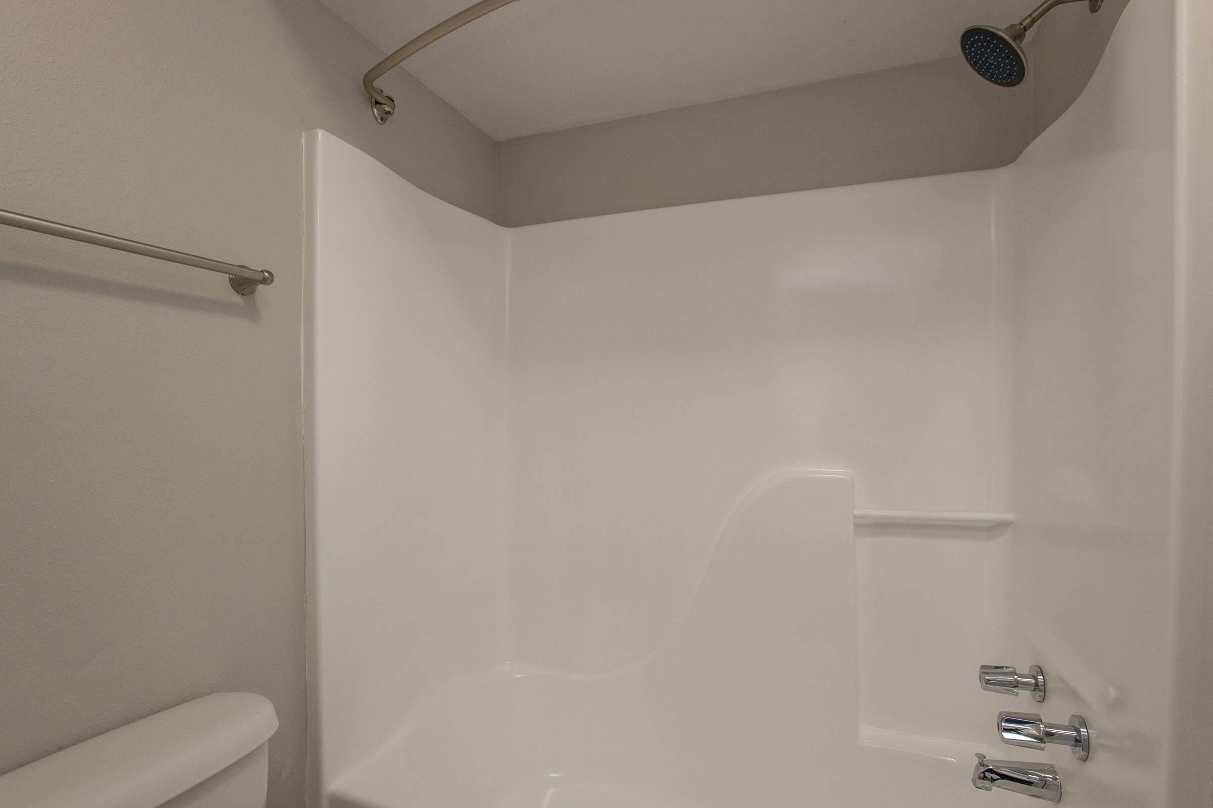 a room with a white tub sitting next to a shower