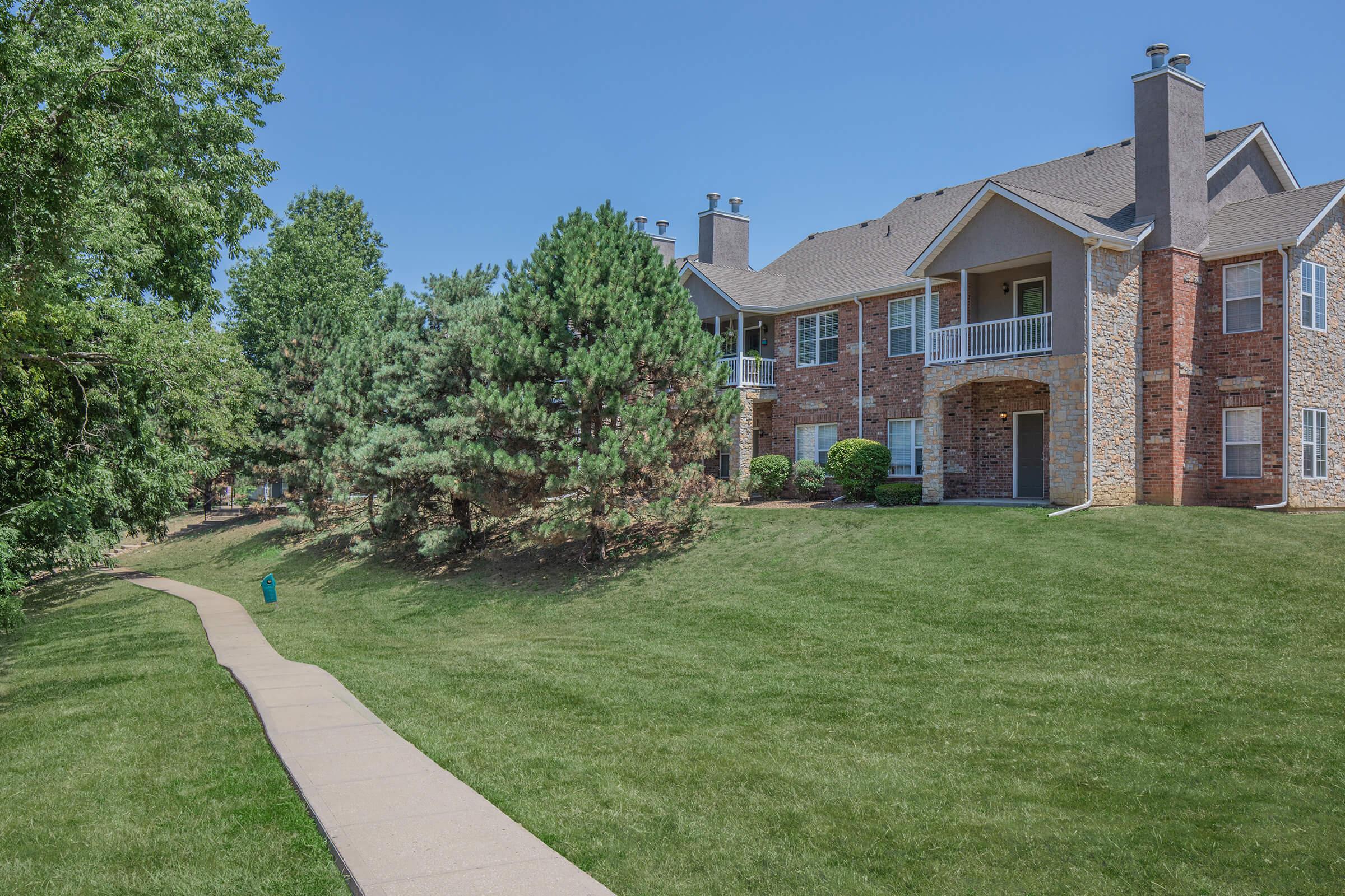 a large lawn in front of a brick building