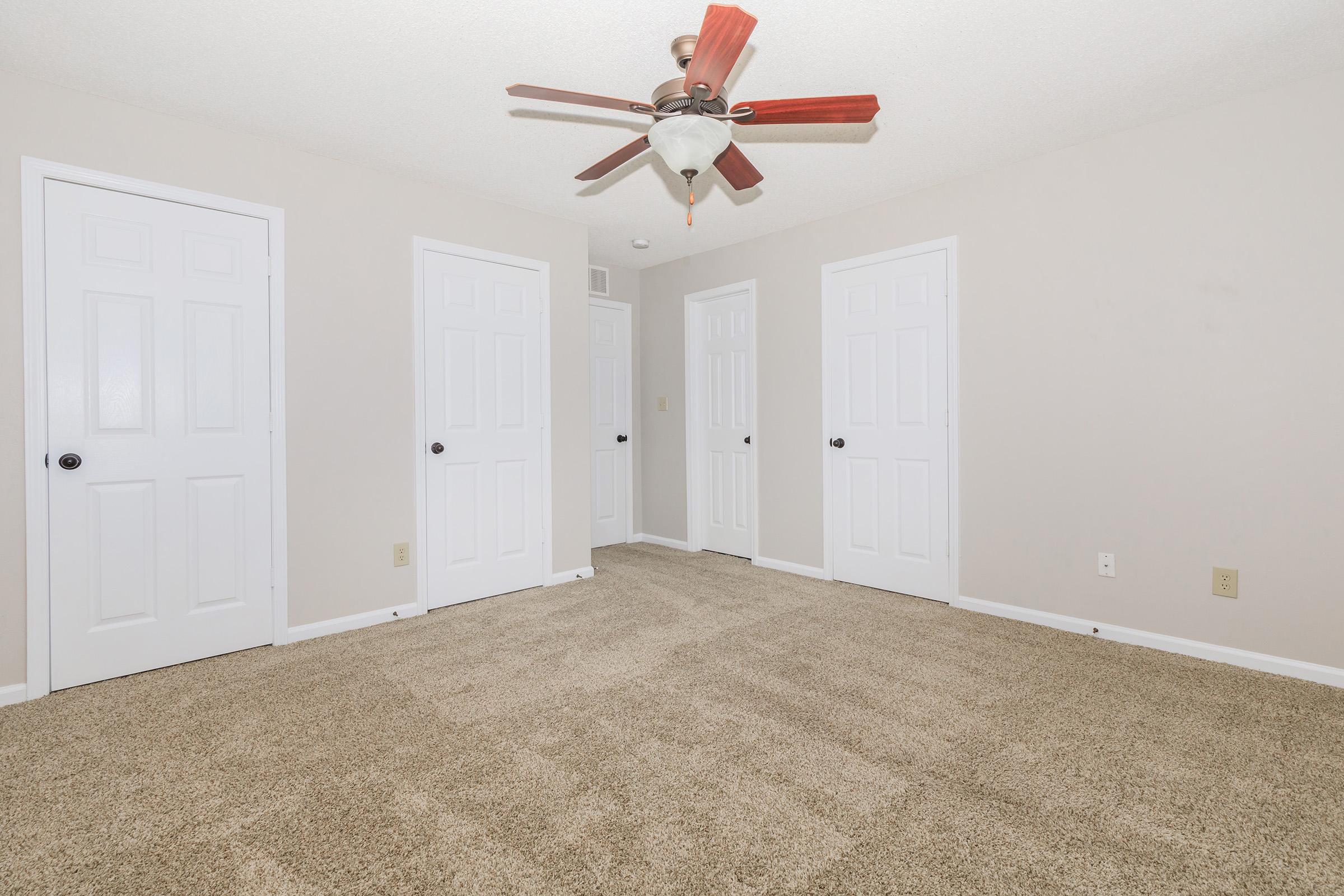 a bedroom with a ceiling fan