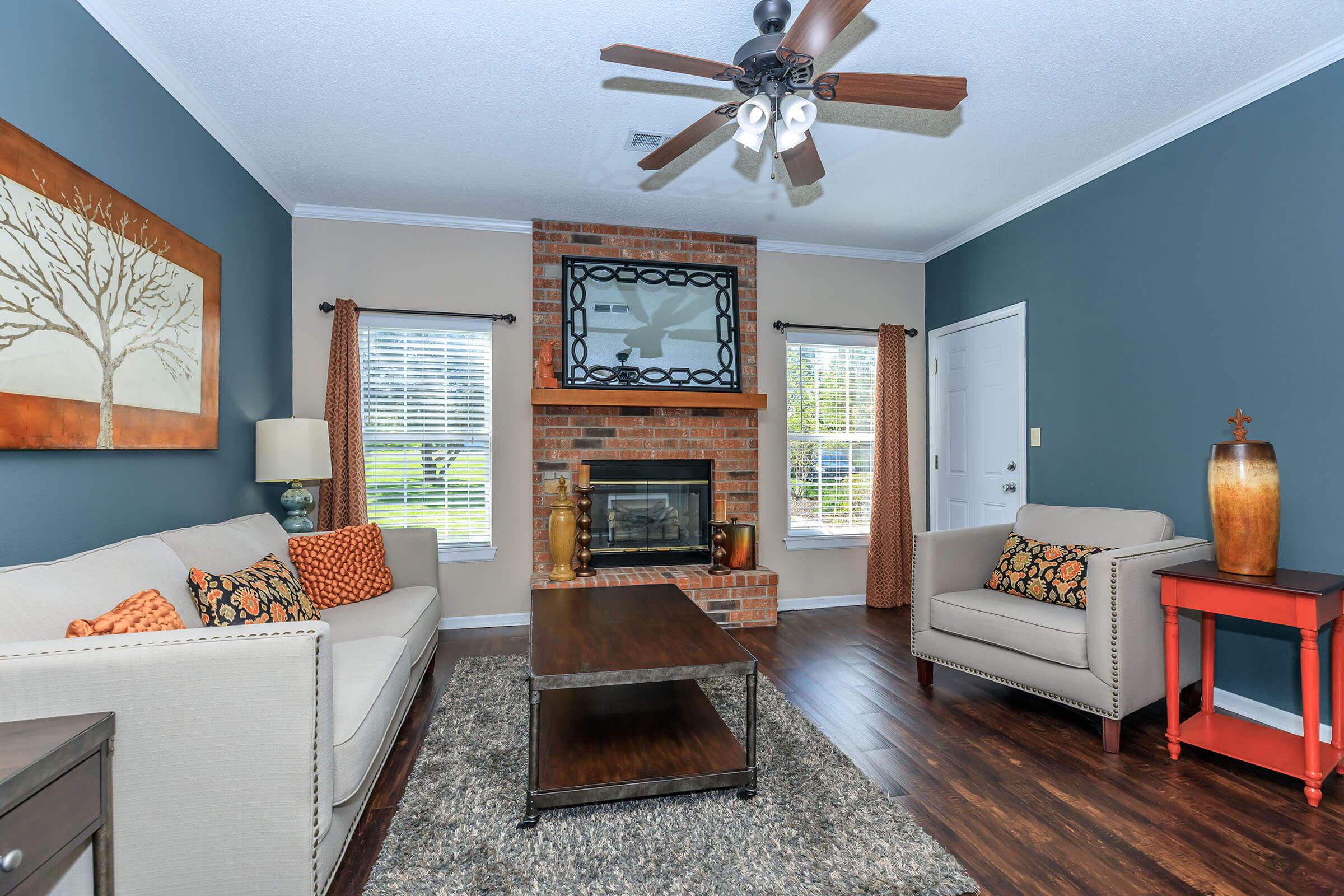 a living room filled with furniture and a fireplace