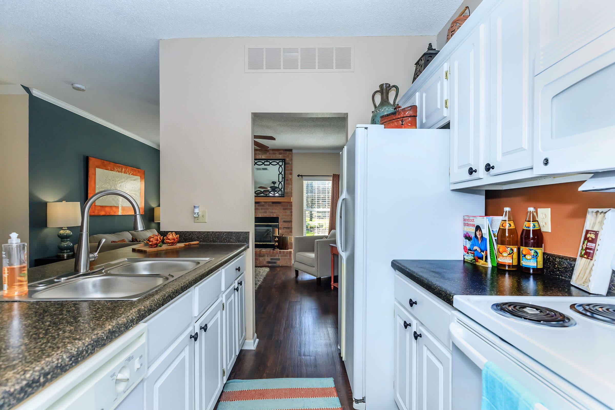 a kitchen with a stove sink and refrigerator