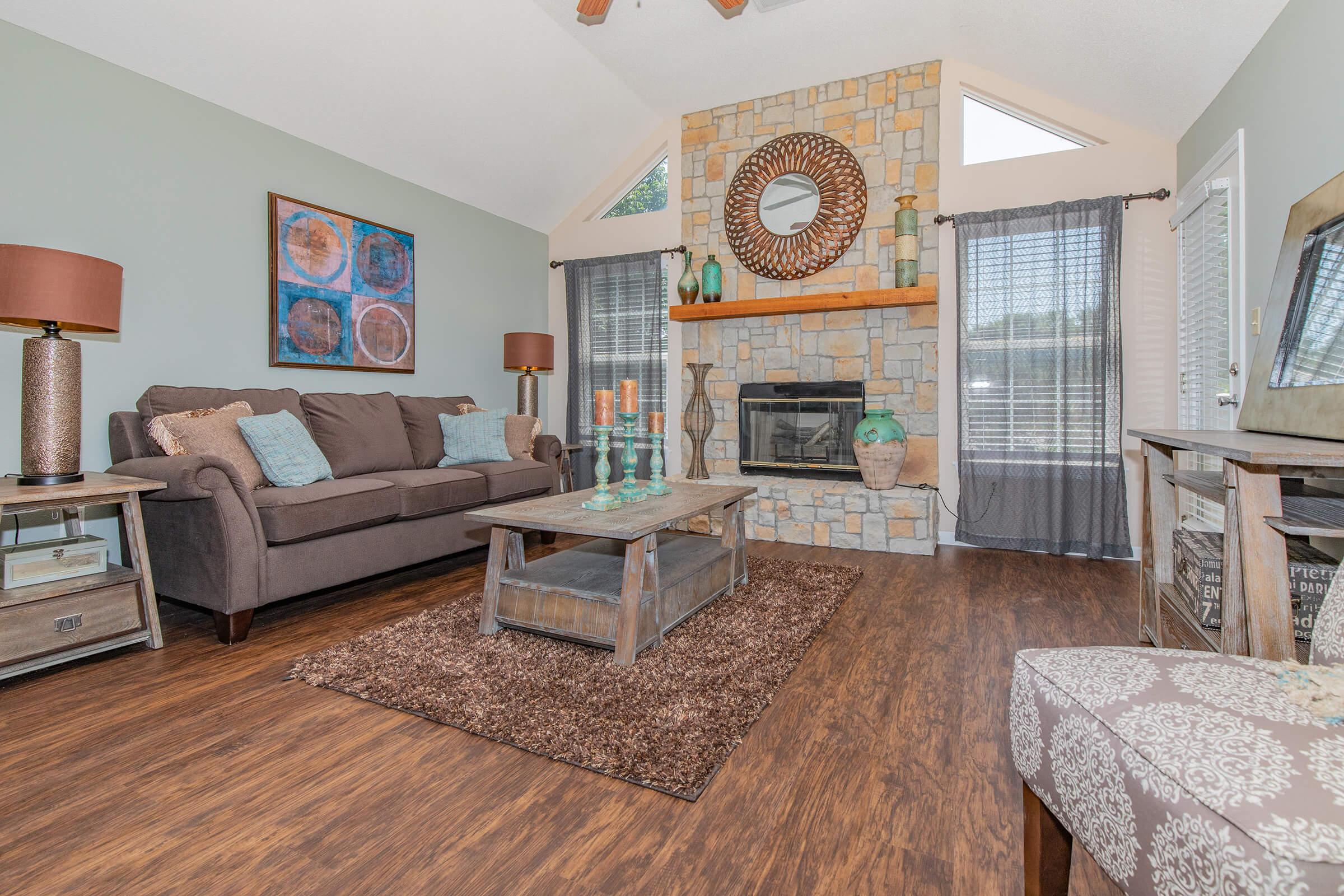 a living room filled with furniture and a fireplace