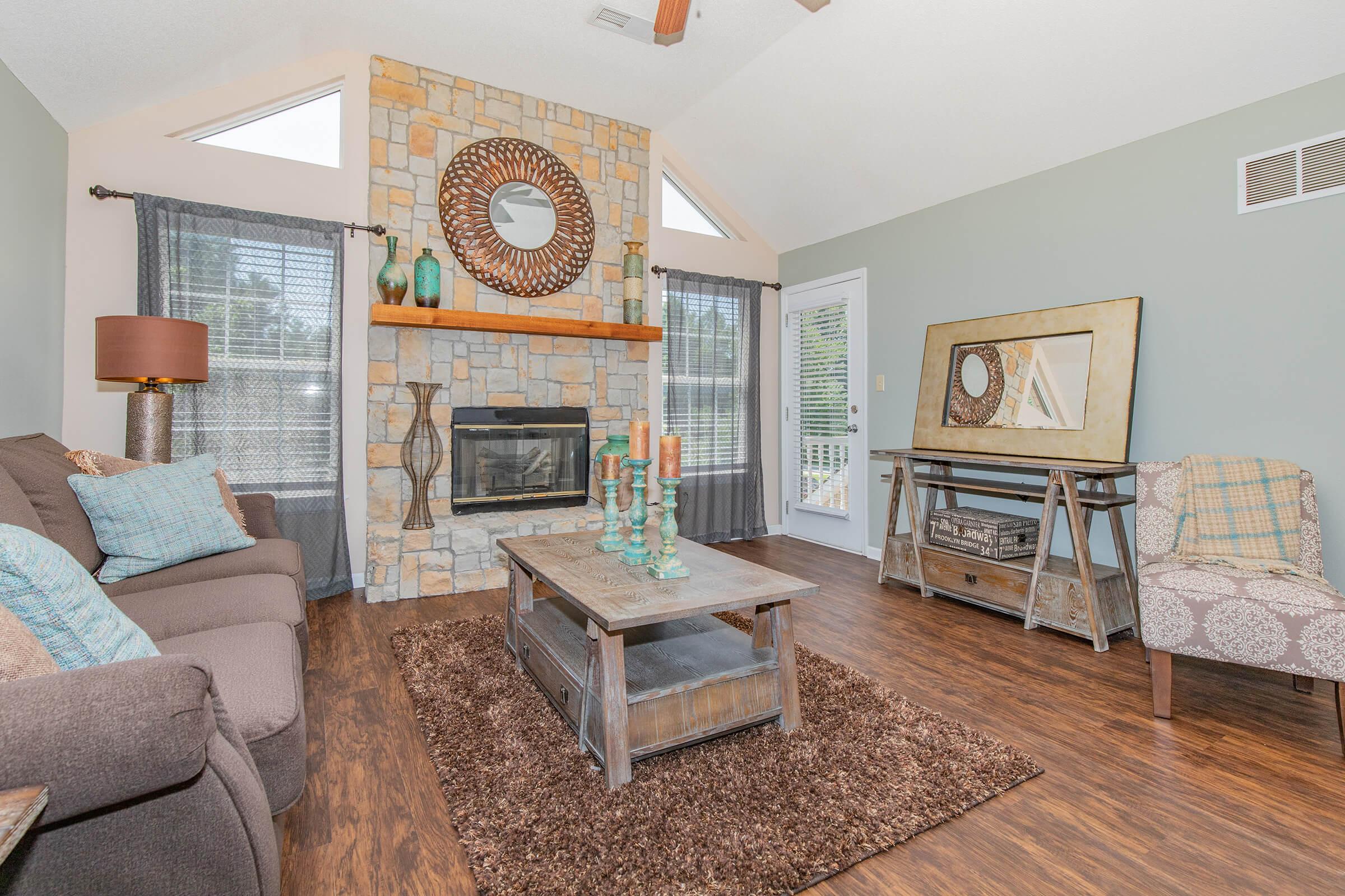 a living room filled with furniture and a fireplace