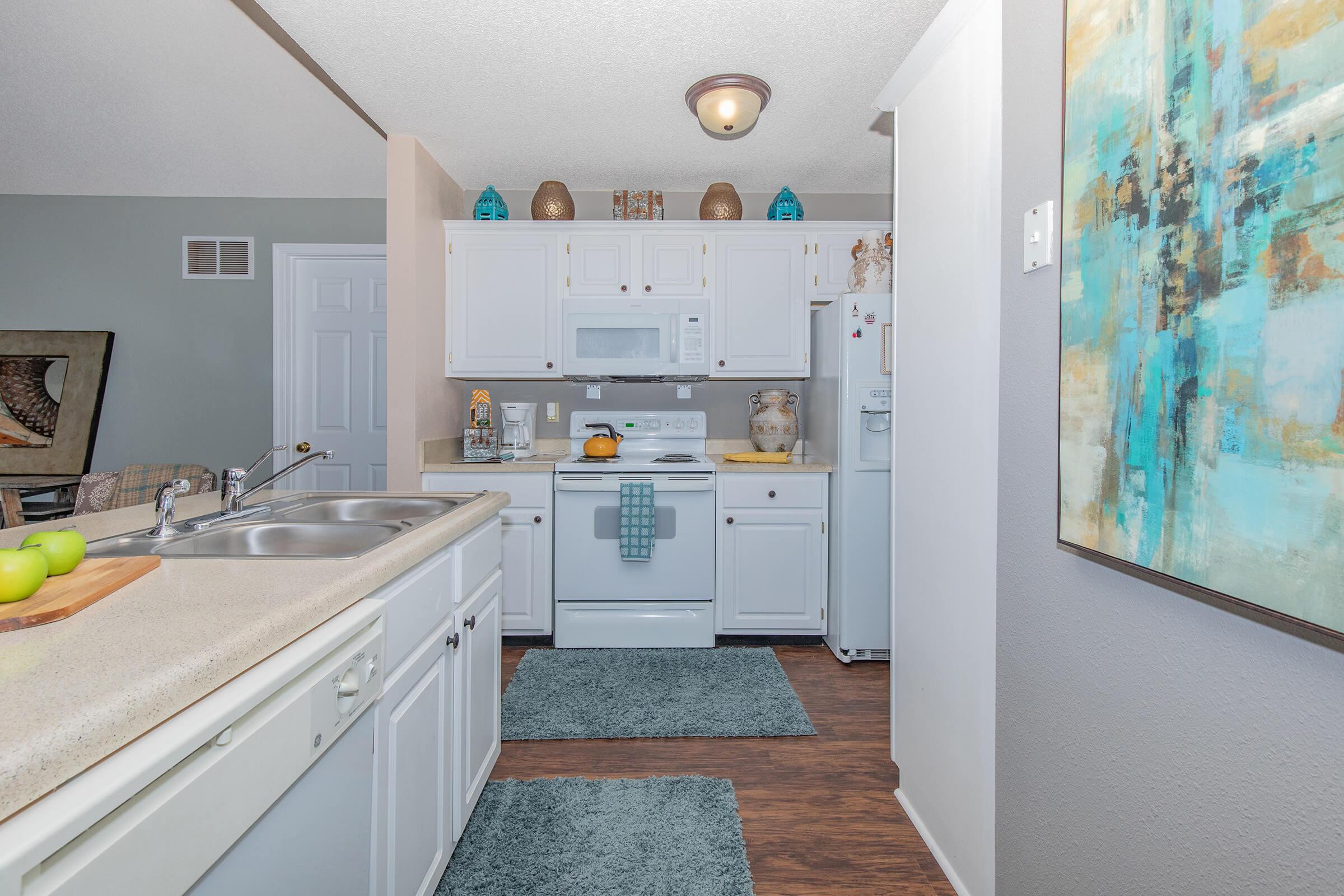 a kitchen with a sink and a mirror