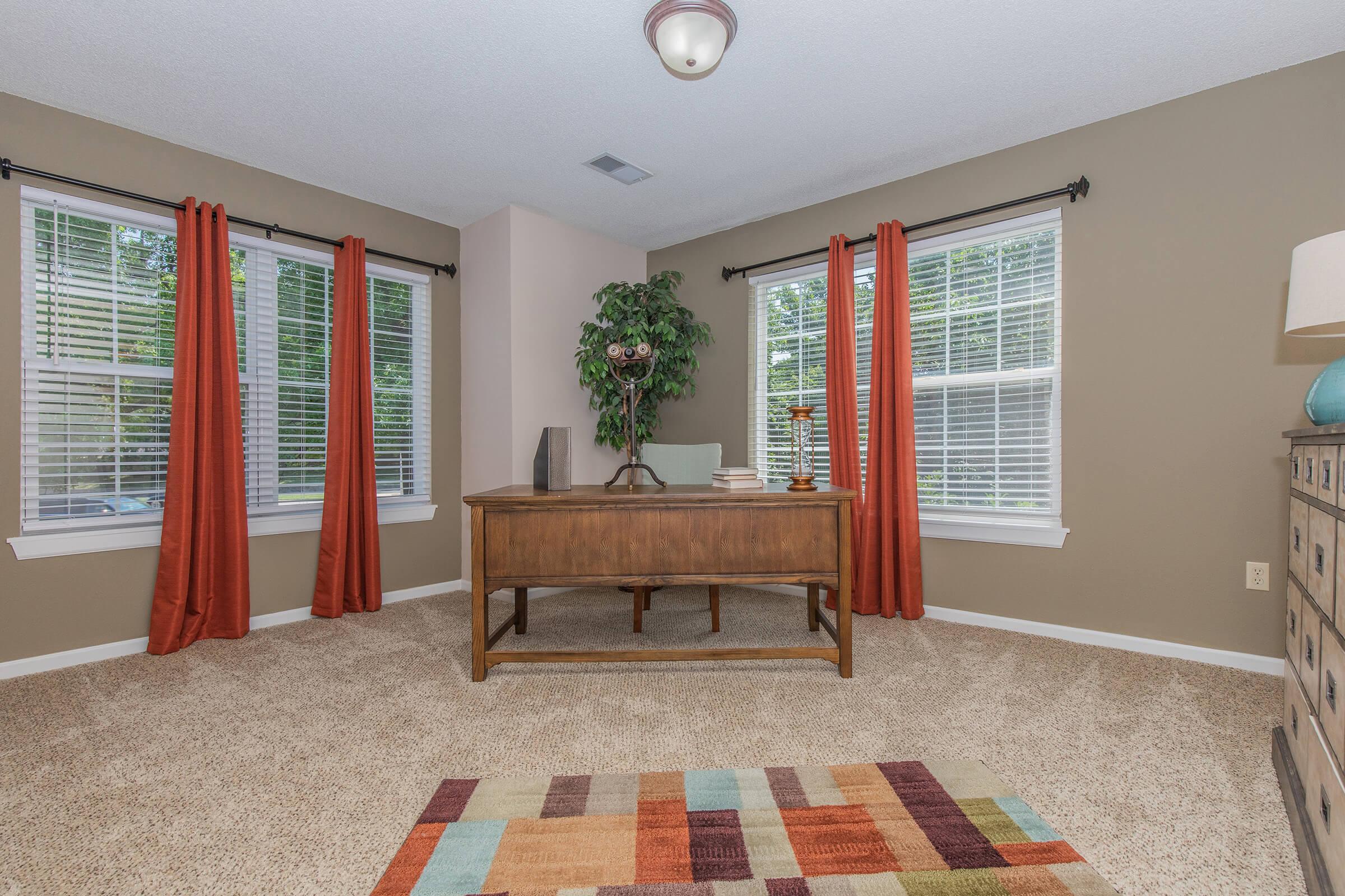 a living room filled with furniture and a large window