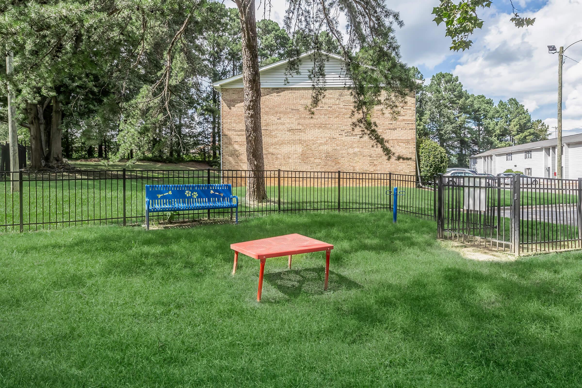 a couple of lawn chairs sitting on top of a grass covered field