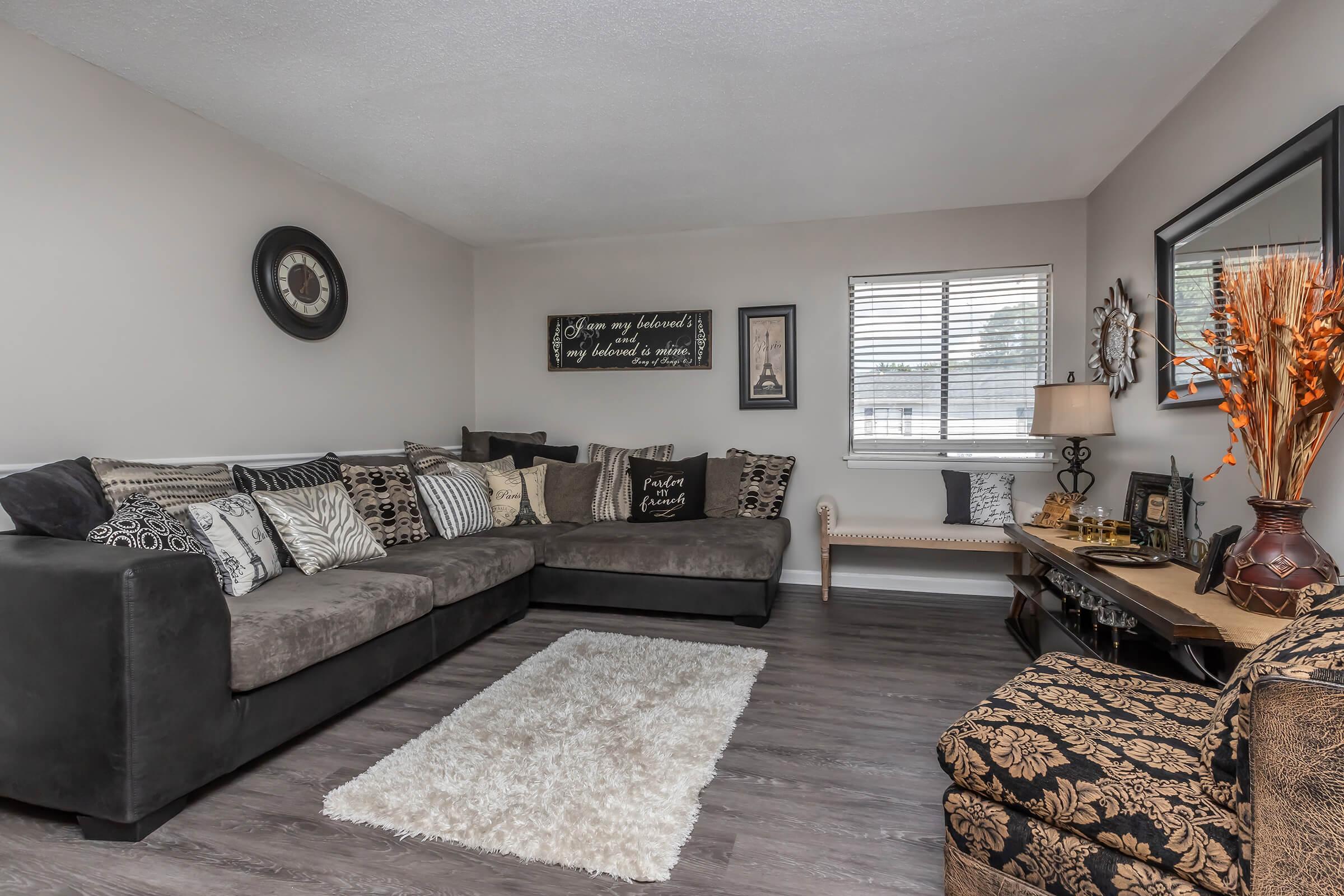 a living room filled with furniture and a large window