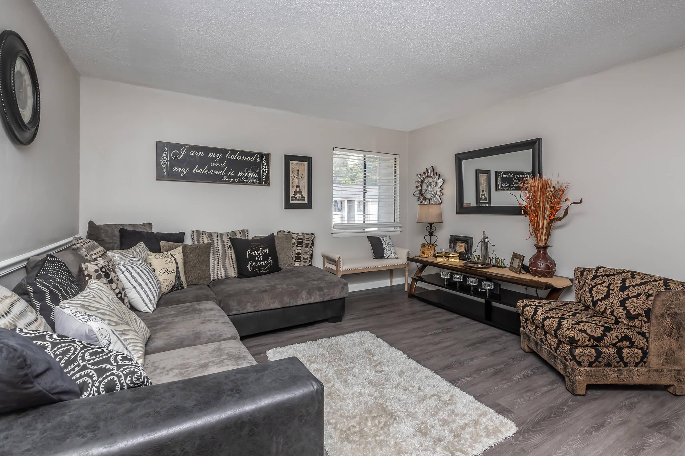 a living room filled with furniture and a flat screen tv