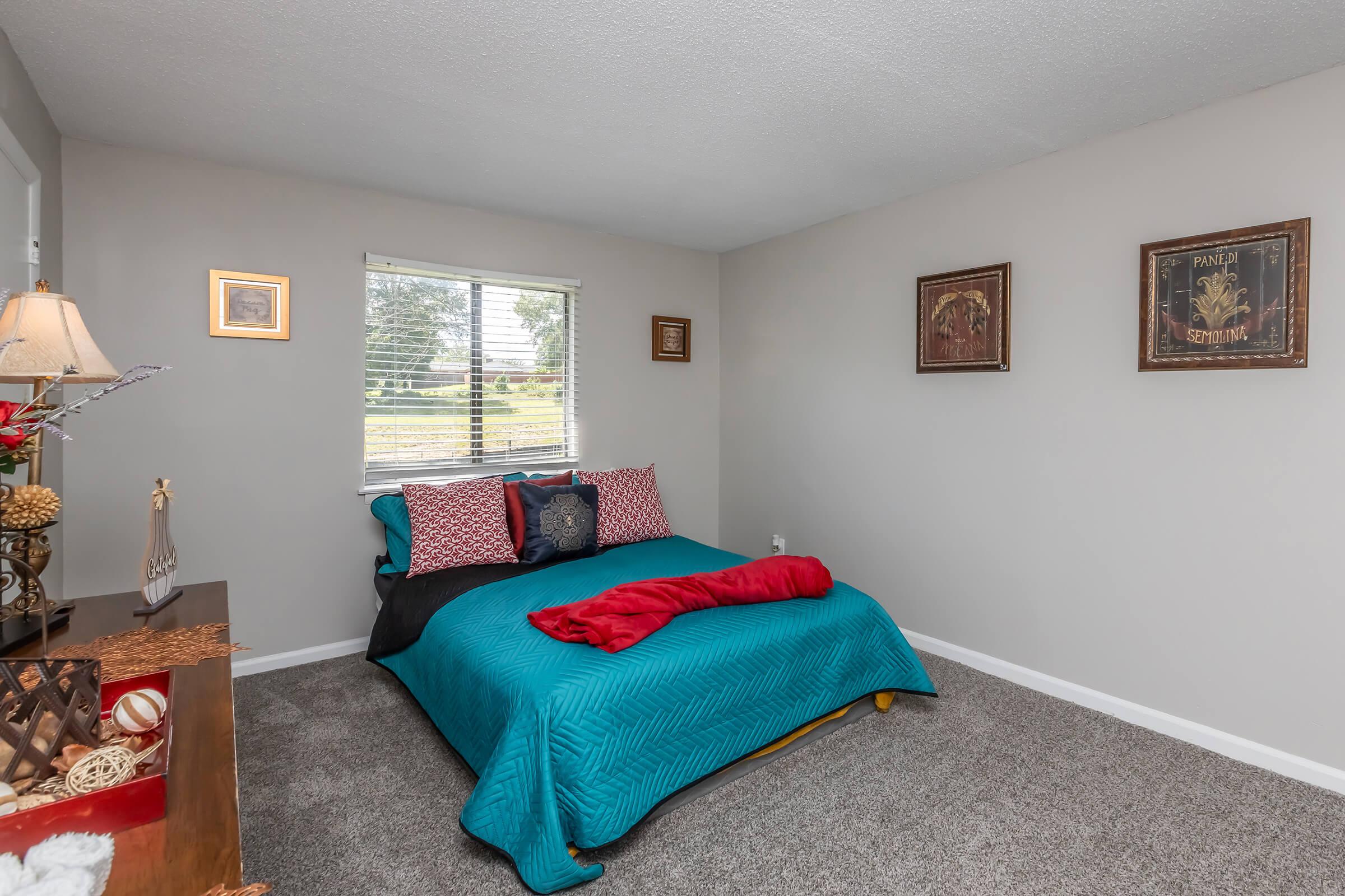 a bedroom with a bed and a couch in a living room