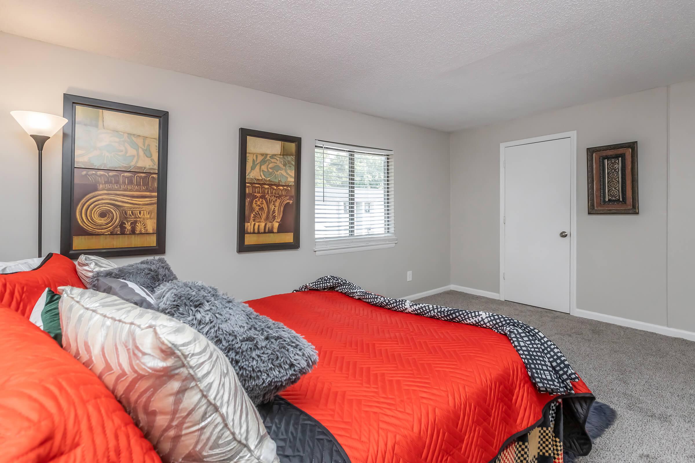 a bedroom with a large bed in a room