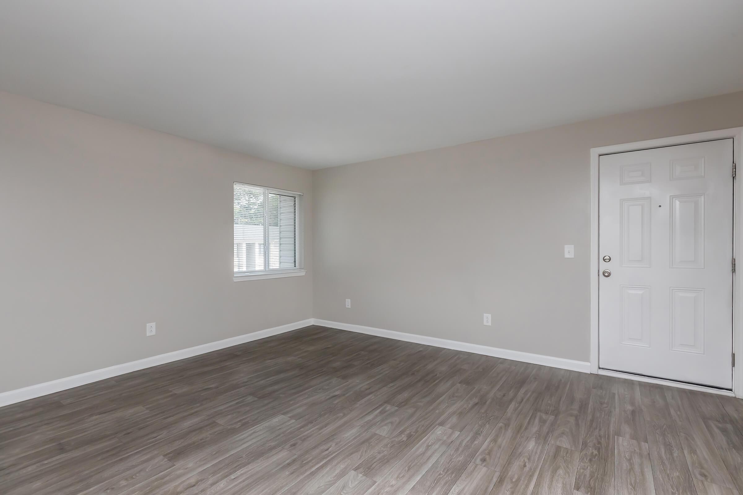 a large empty room with a wooden floor