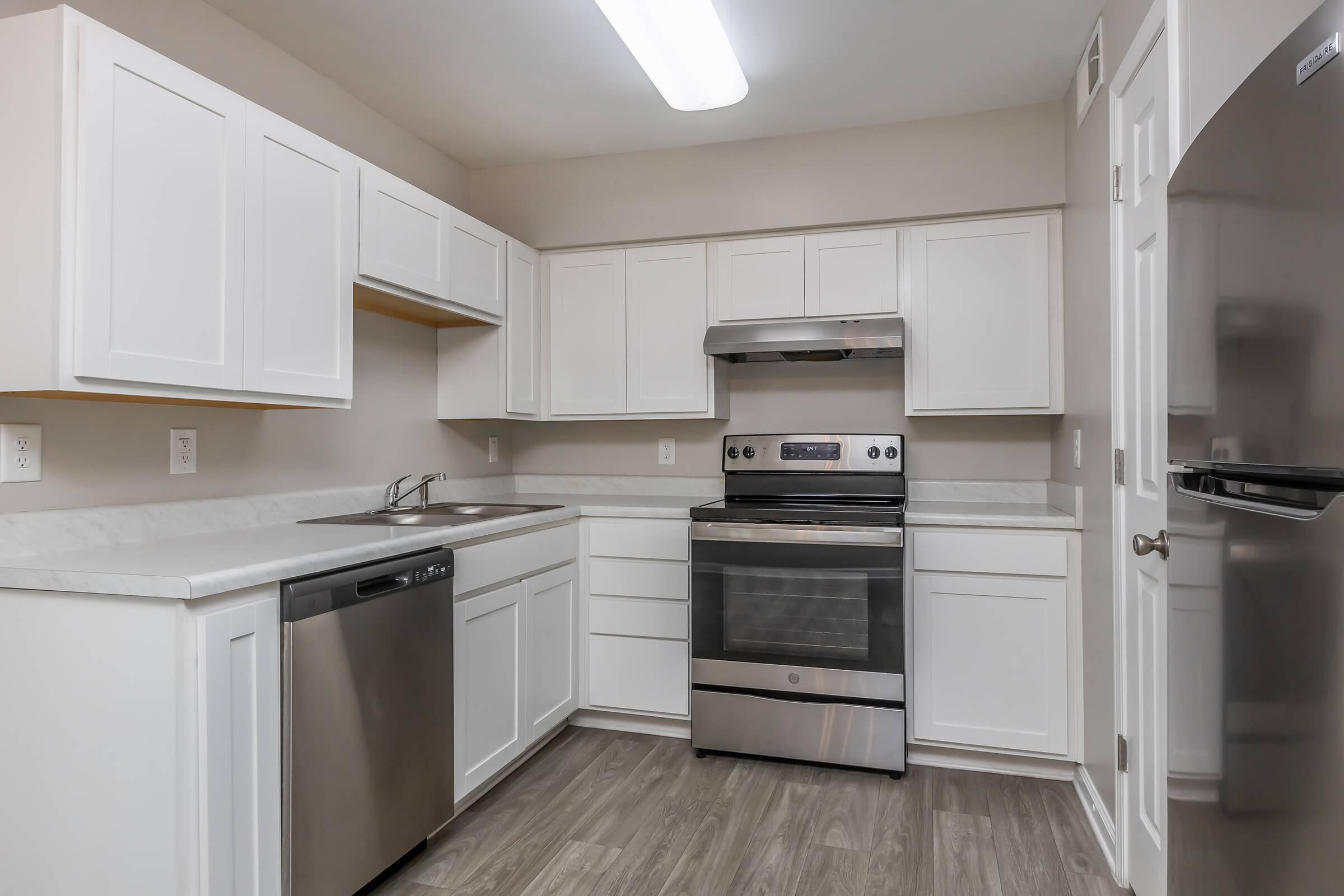 a kitchen with a stove and a refrigerator