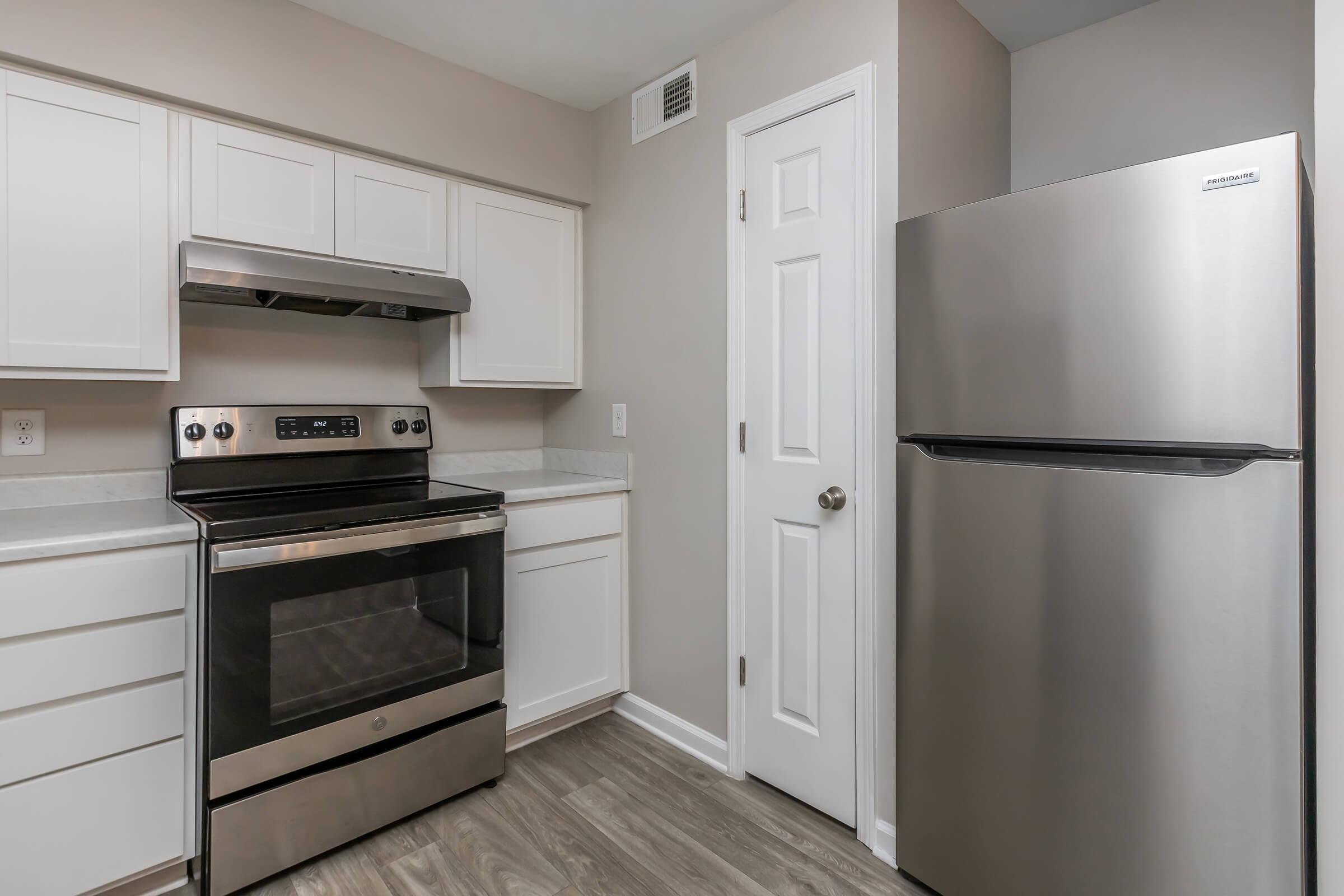 a kitchen with a stove and a refrigerator