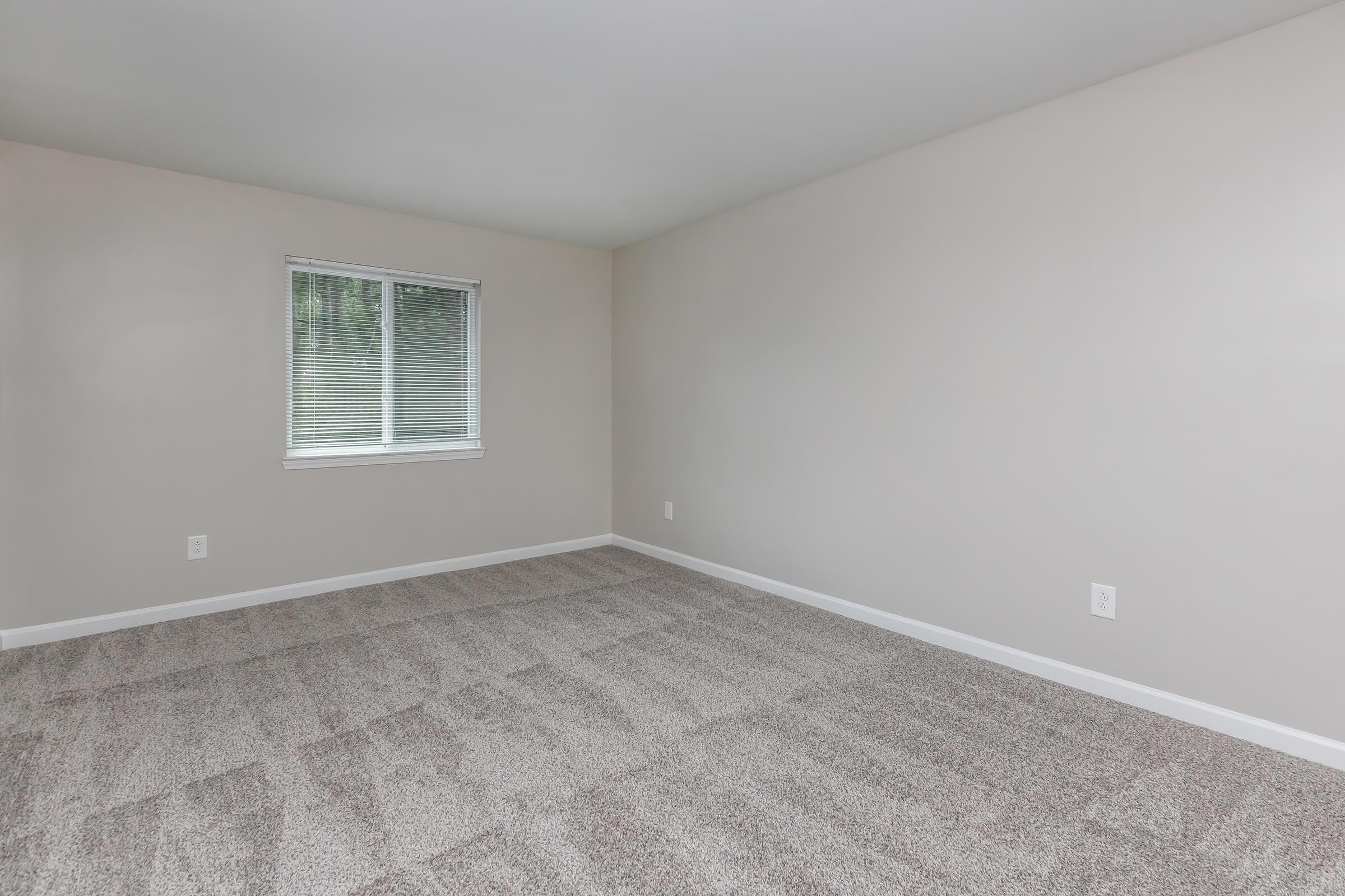 a bedroom with a large window