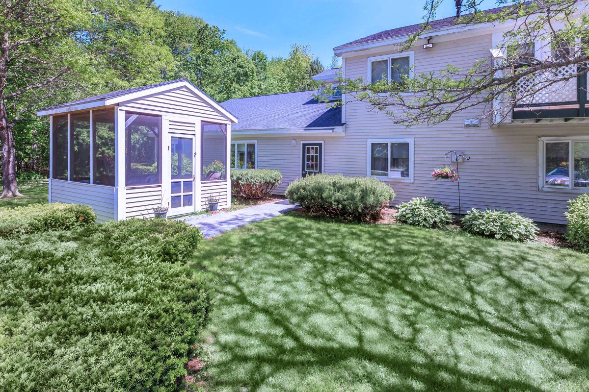 a house with bushes in front of a building