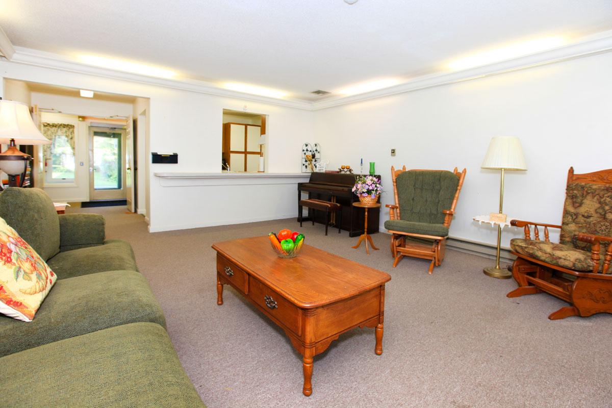 a living room filled with furniture and a bed