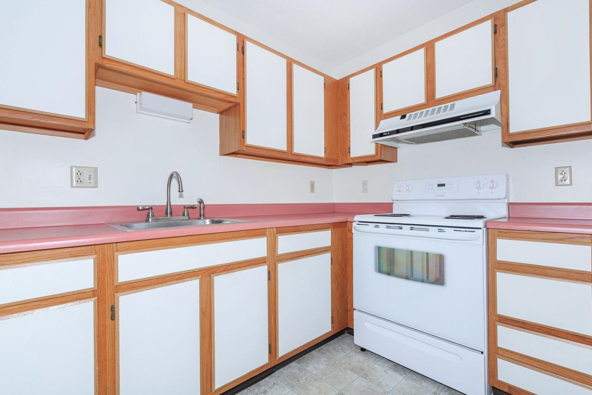 a kitchen with wooden cabinets